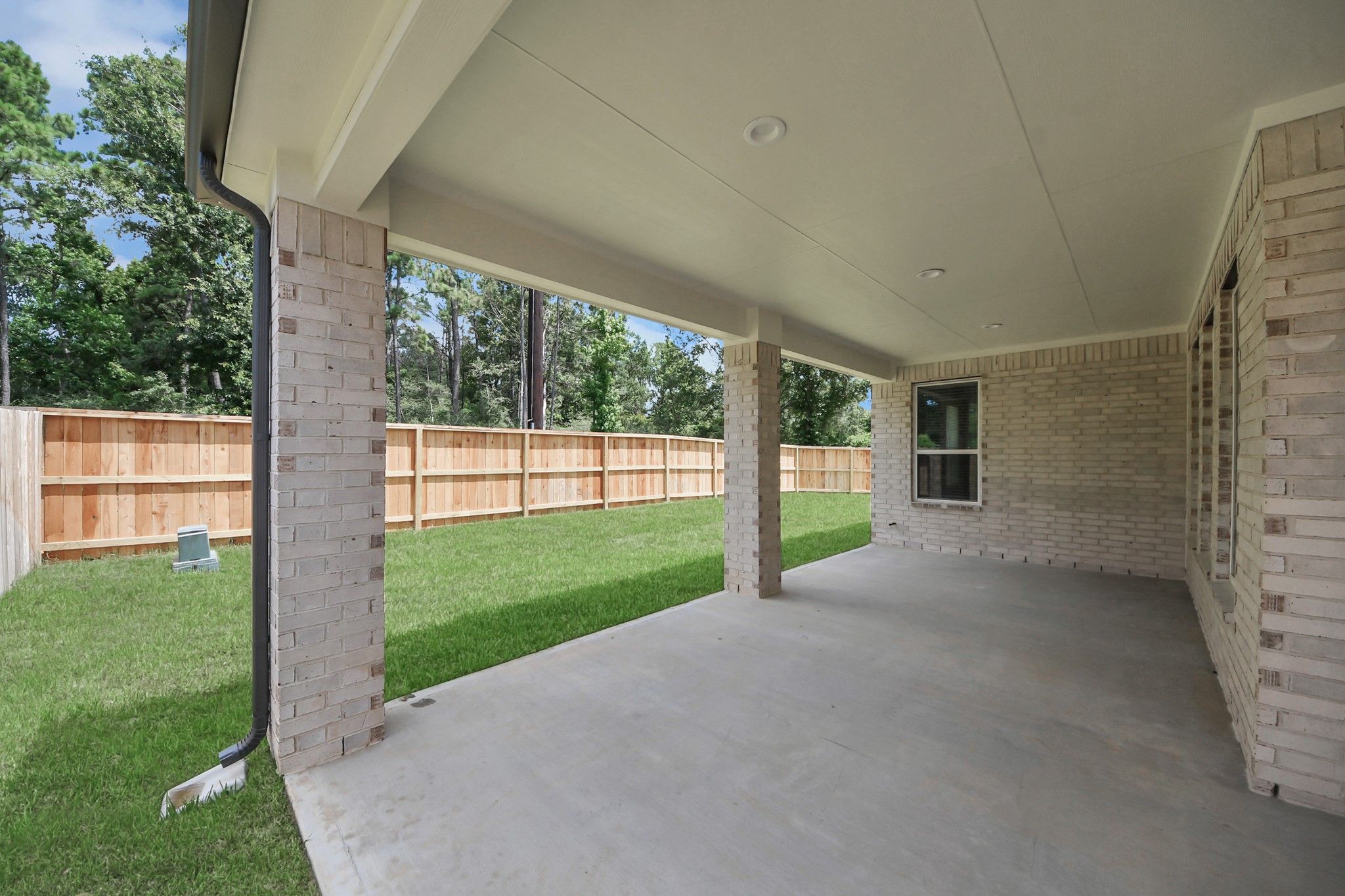 Experience outdoor living at its finest on this expansive covered patio, thoughtfully designed for BBQs and delightful outdoor dining. Sample photo of completed home with similar floor plan. Actual colors and selections may vary.