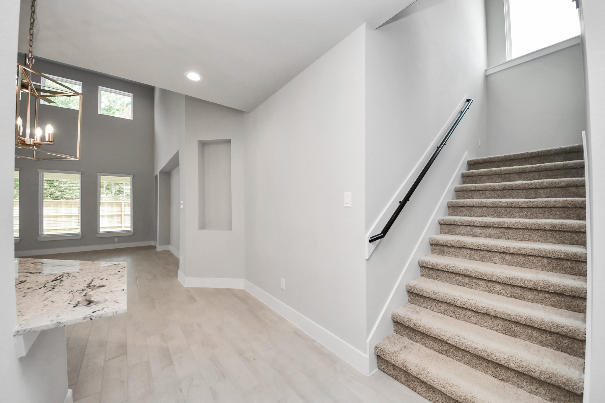 Entrance to the living room and kitchen area. Sample photo of completed home with similar floor plan. Actual colors and selections may vary.