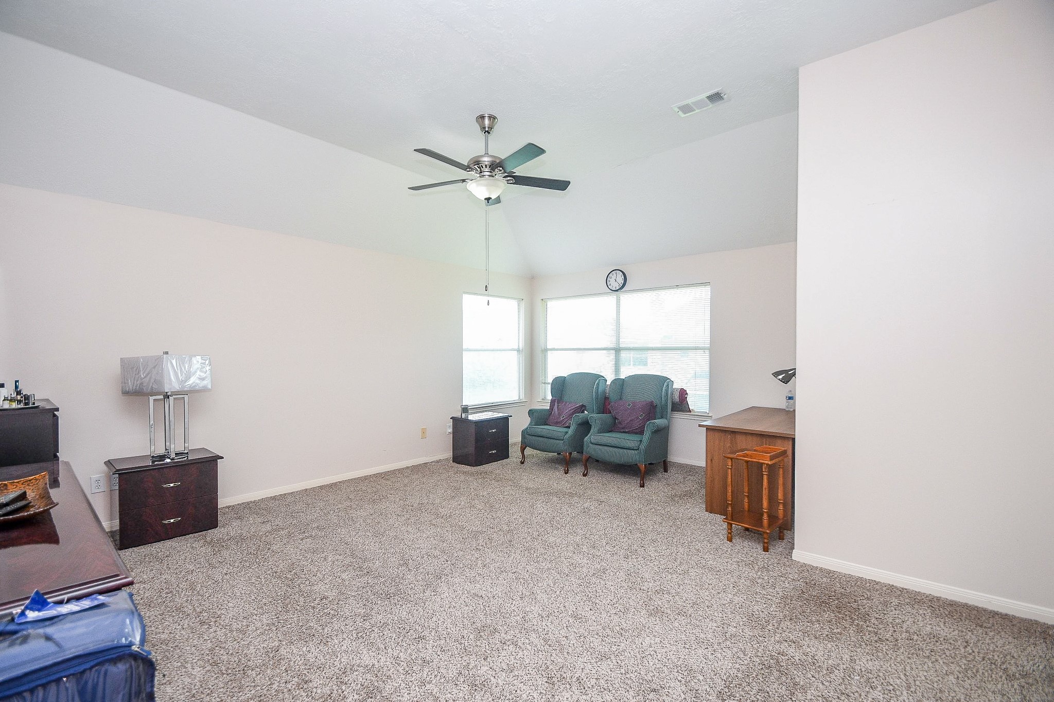Incredibly spacious Primary suite featuring large windows to provide natural light. Ensuite bath