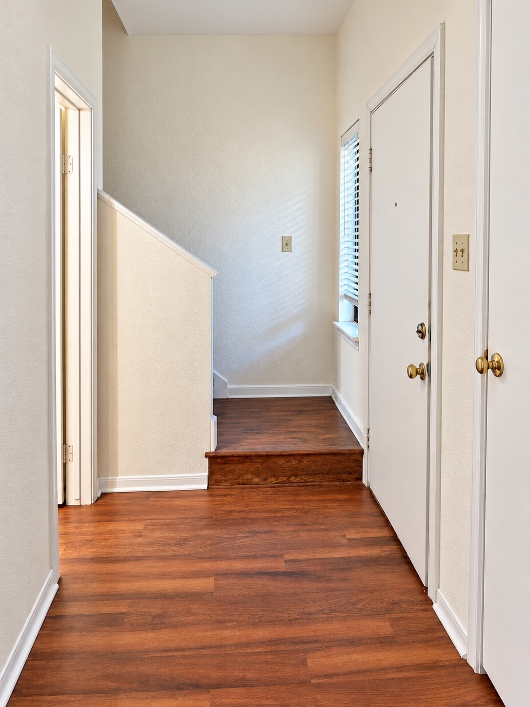 Entryway with wodded-look flooring,natural lighting and , a convenient coat closet.