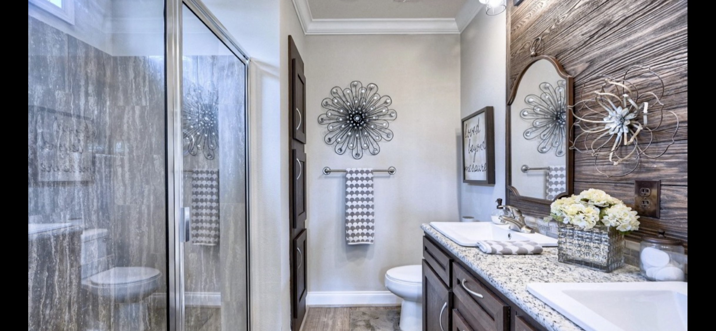 Primary bath features a separate shower & double-sink vanity, with decorative finishes that complement the homes interior.