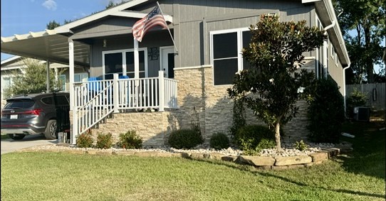 Landscaped flower beds, stone accents & a welcoming covered porch enhance the exterior. Front solar screens & a sprinkler system add everyday convenience.