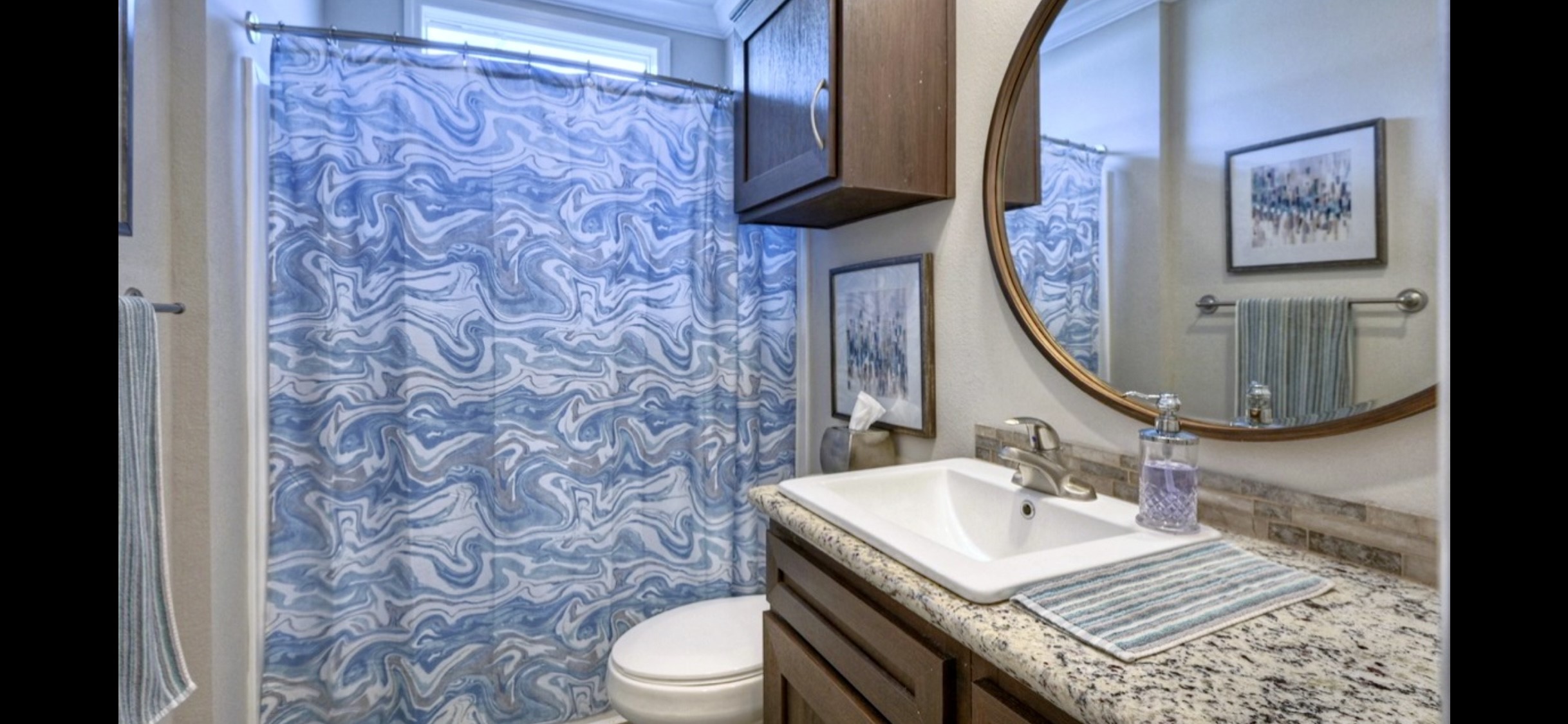 Secondary bath features a tub/shower combination, vanity storage & coordinating finishes.