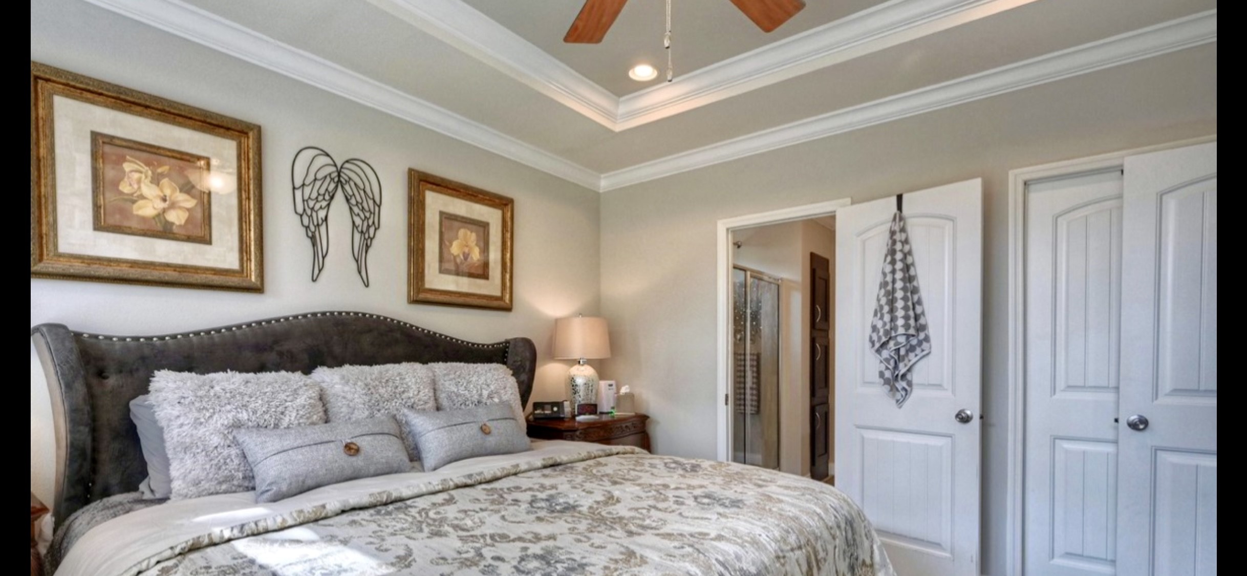 Relax in the primary bedroom featuring a decorative tray ceiling, crown molding & ceiling fan. Suite includes a walk-in closet & private bath.