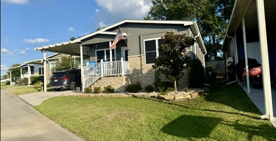 Enjoy Lake Conroe area living in this upgraded 2019 home featuring 2 bedrooms, 2 baths, a covered front porch & attached carport. Home only; land leased. Thousand Trails membership required.