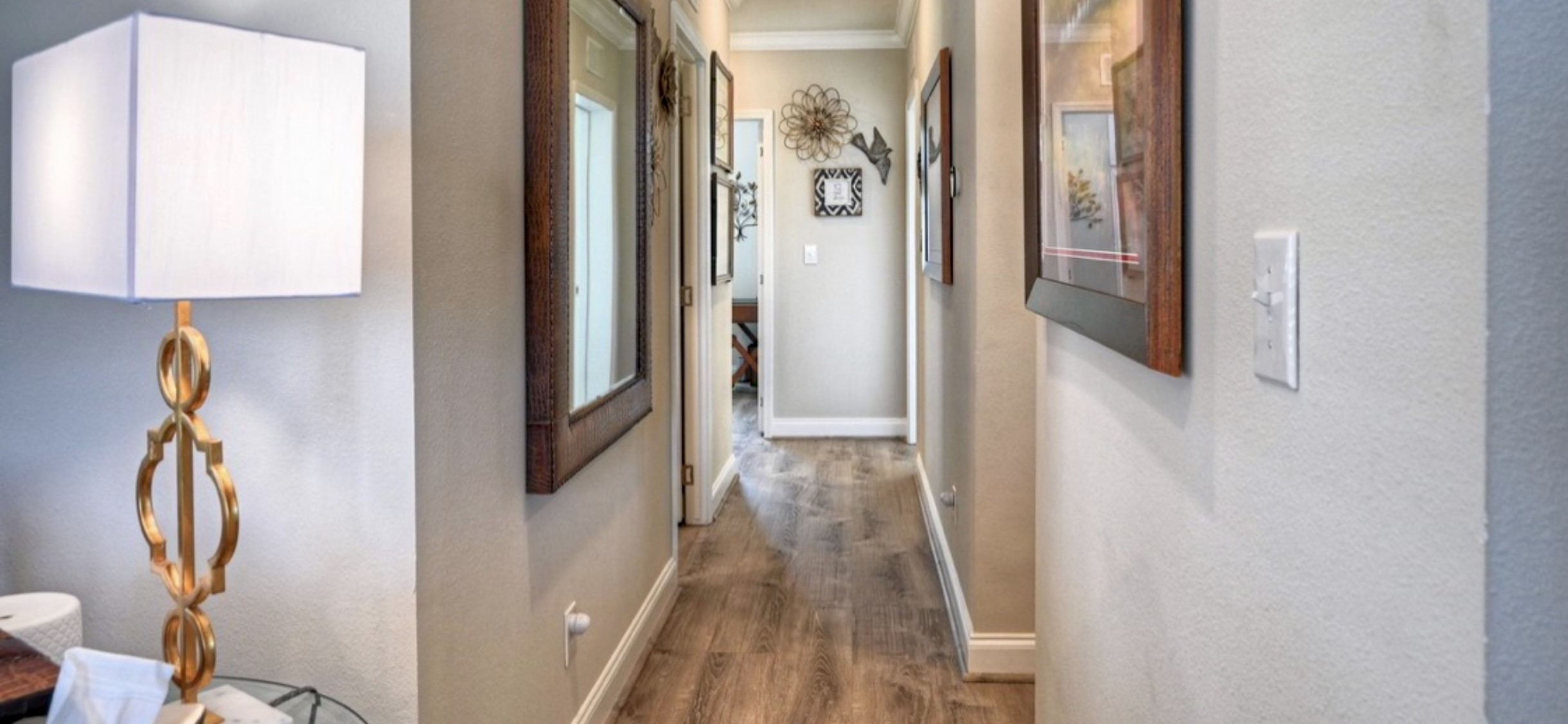 Upgraded flooring continues through the hallway, connecting the main living area to the bedrooms & baths.