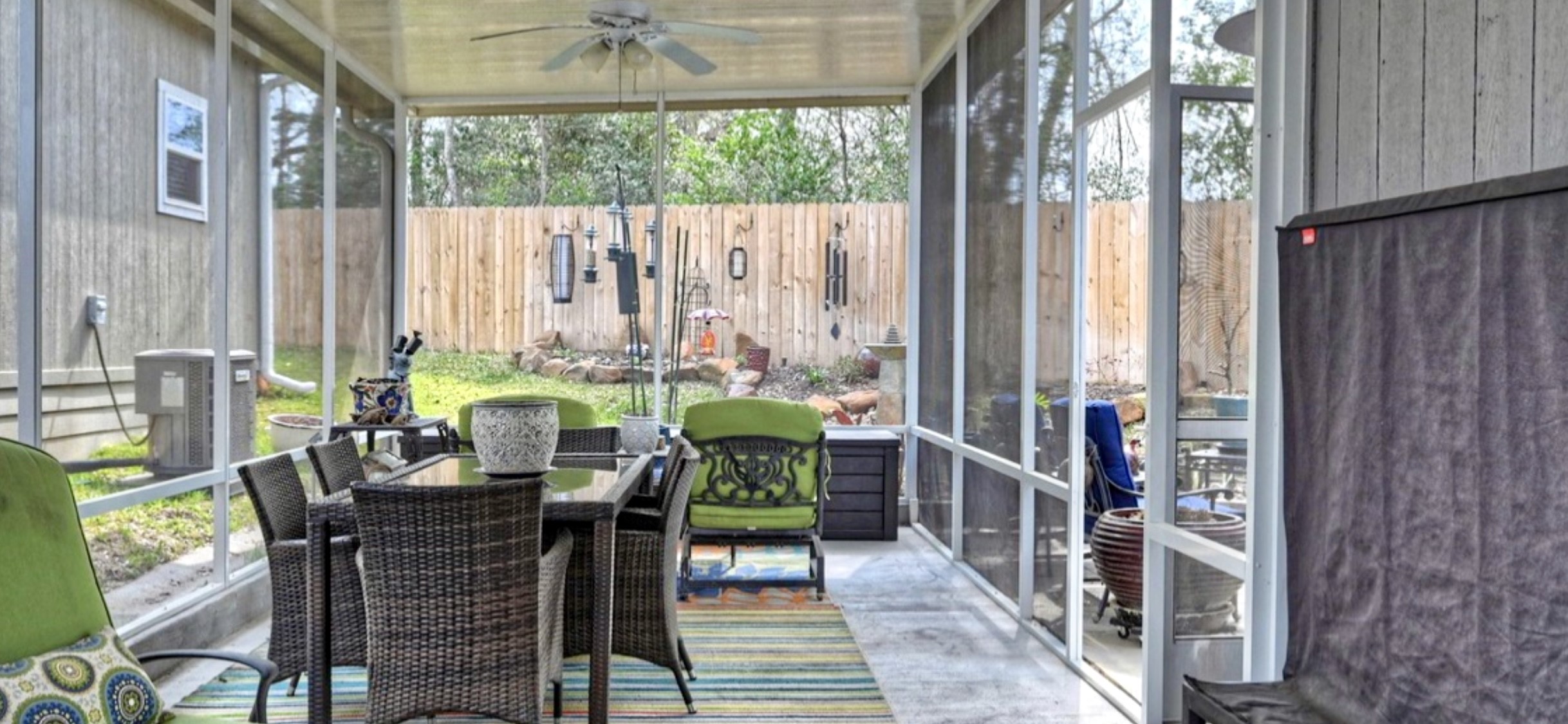 Extended screened-in room provides additional space for seating, dining & enjoying the outdoors, complete with a ceiling fan.