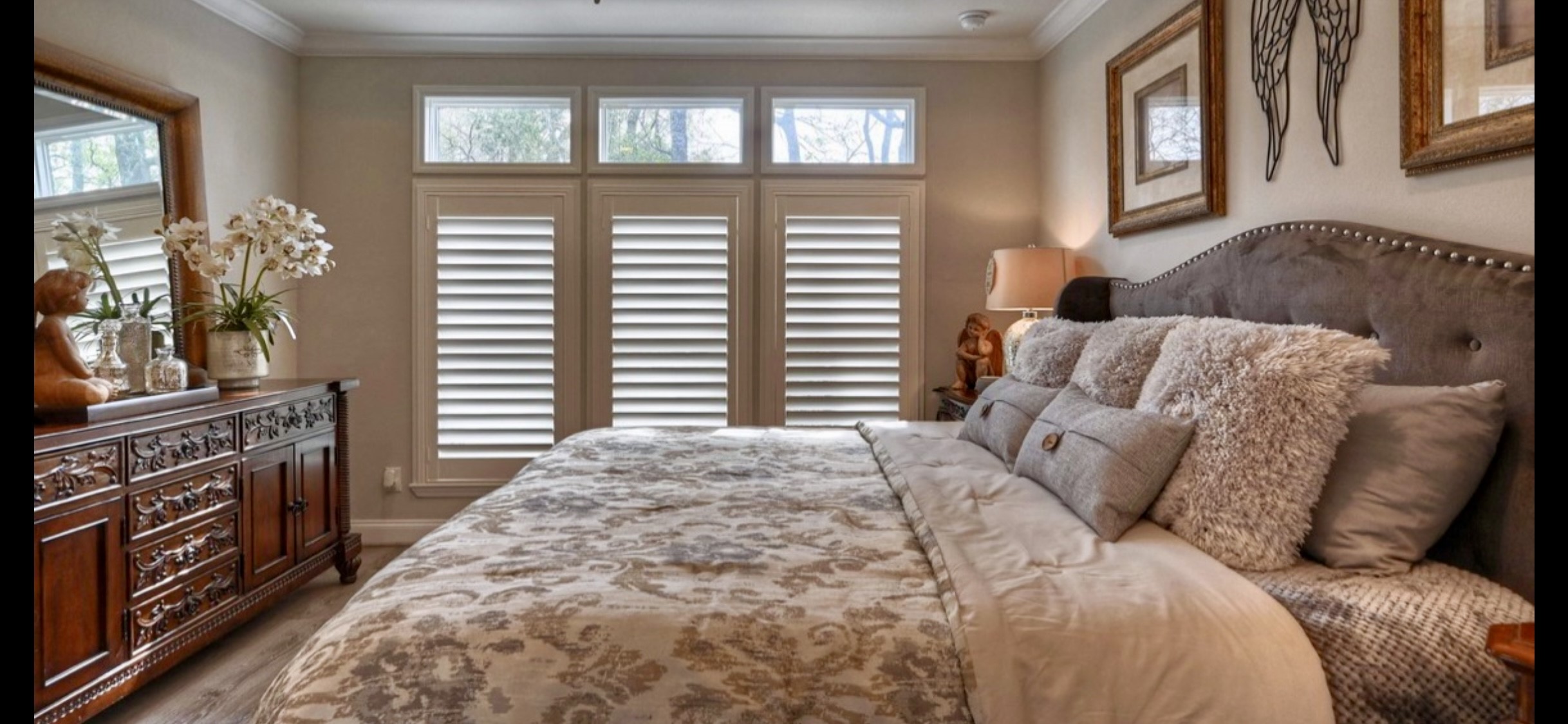 Alternate view showcases the primary bedrooms shuttered windows, transom windows & upgraded flooring.