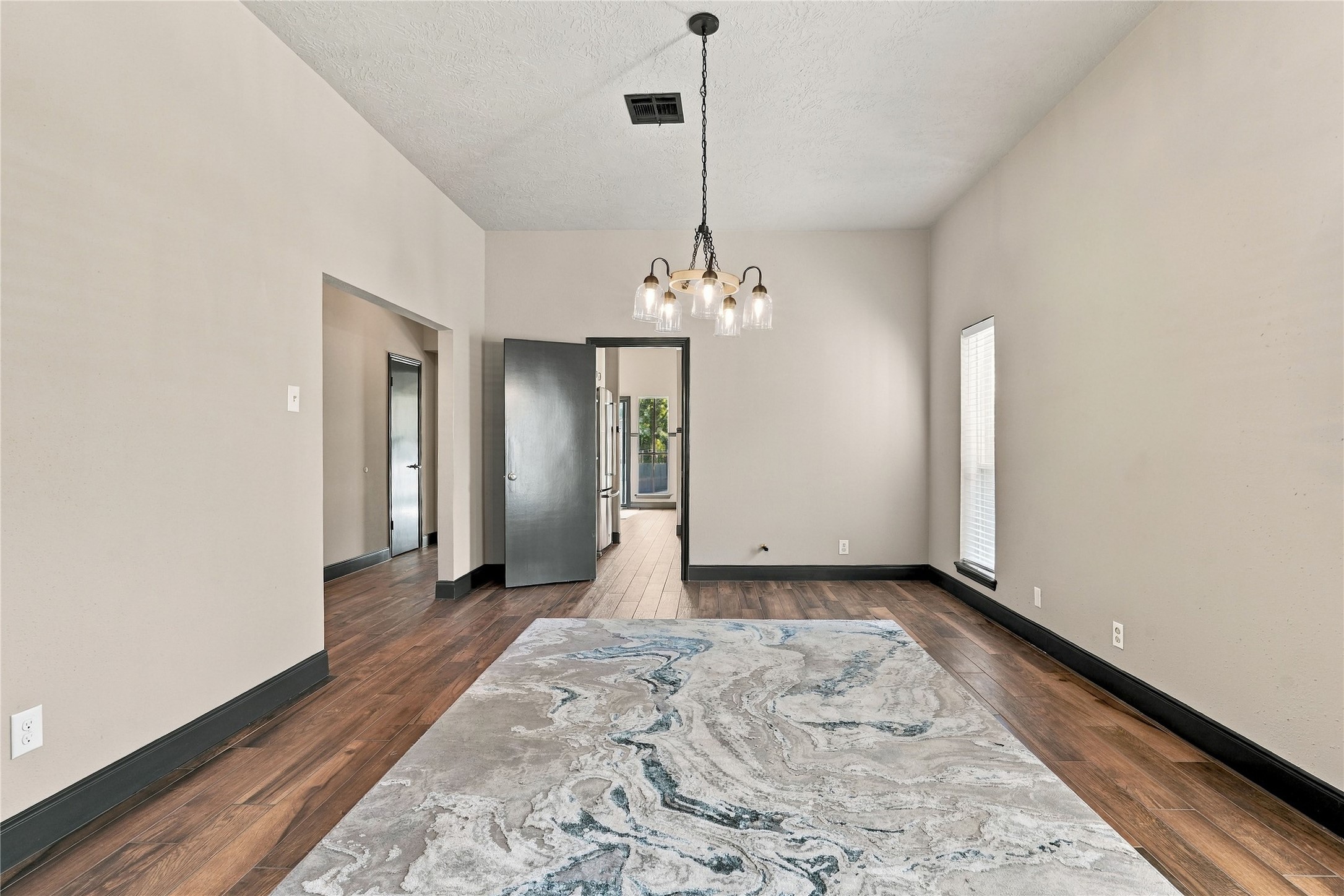 Additional view of the formal dining room highlighting its generous dimensions and convenient access to the kitchen.
