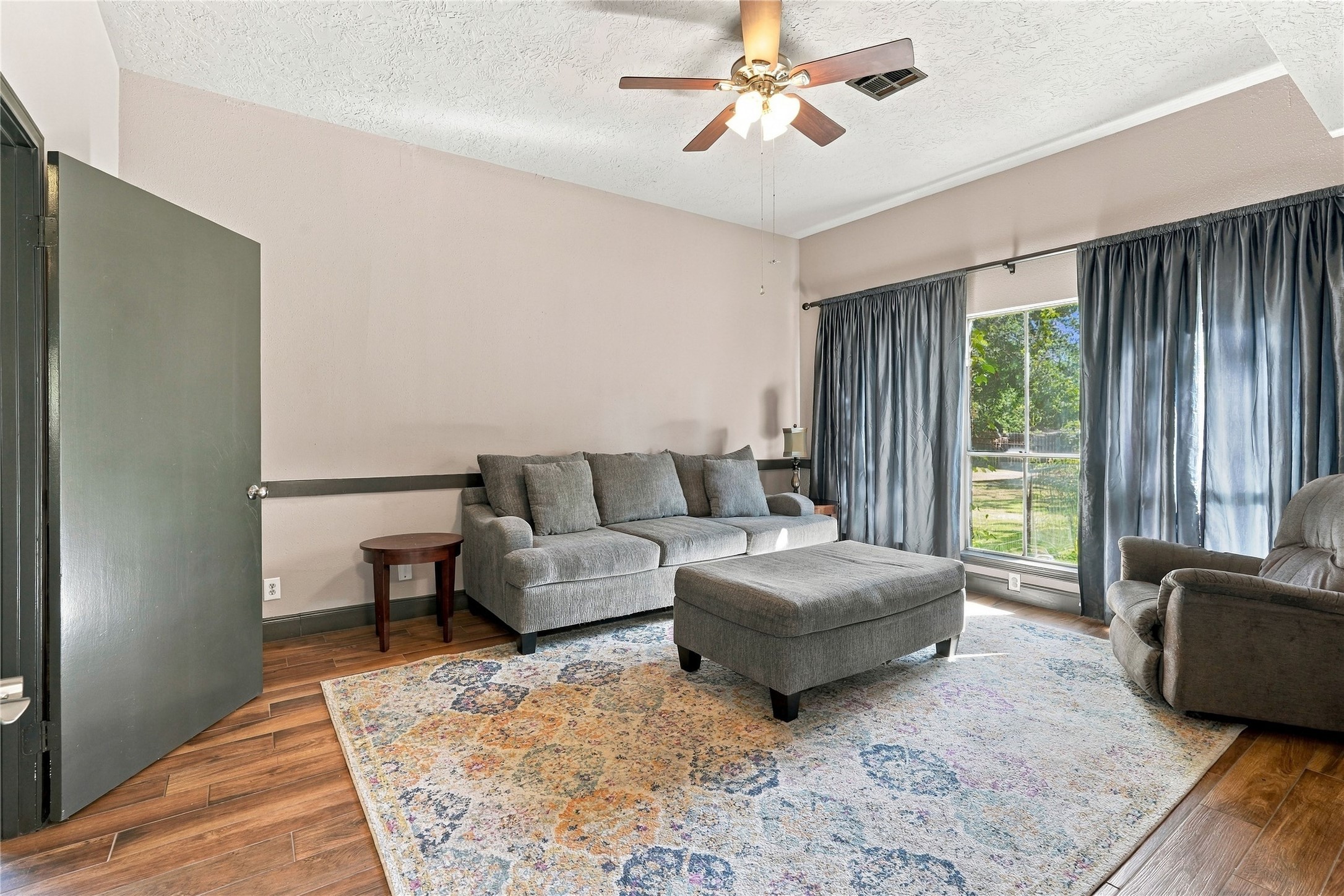 Additional family room view highlighting the spacious layout, natural light, and flexible furniture arrangement.