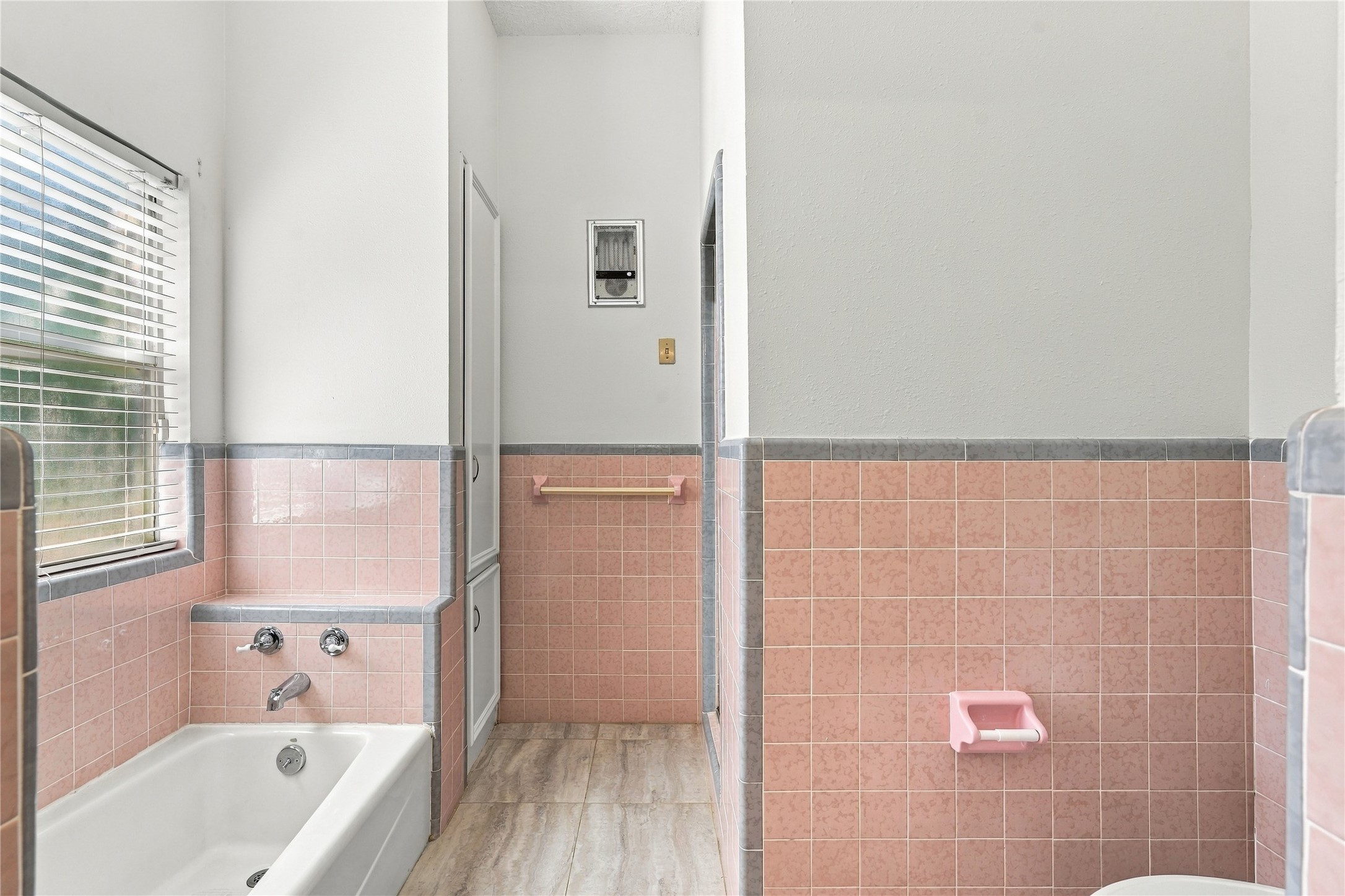 Additional view of the primary bathroom showcasing the soaking tub, separate shower, tile surround, and natural light.