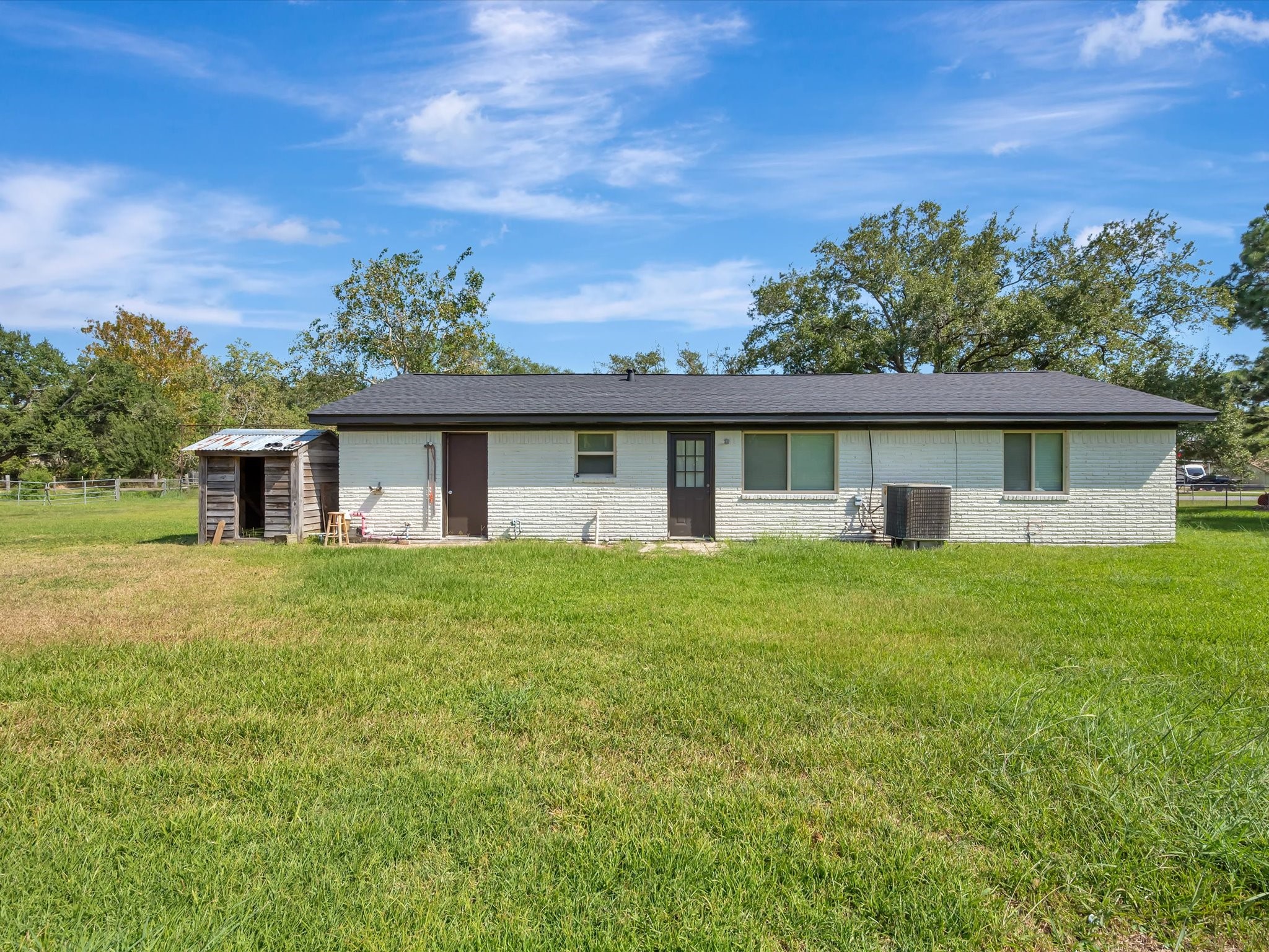 Spacious backyard featuring well-maintained green grass. Spacious backyard featuring well-maintained green grass.