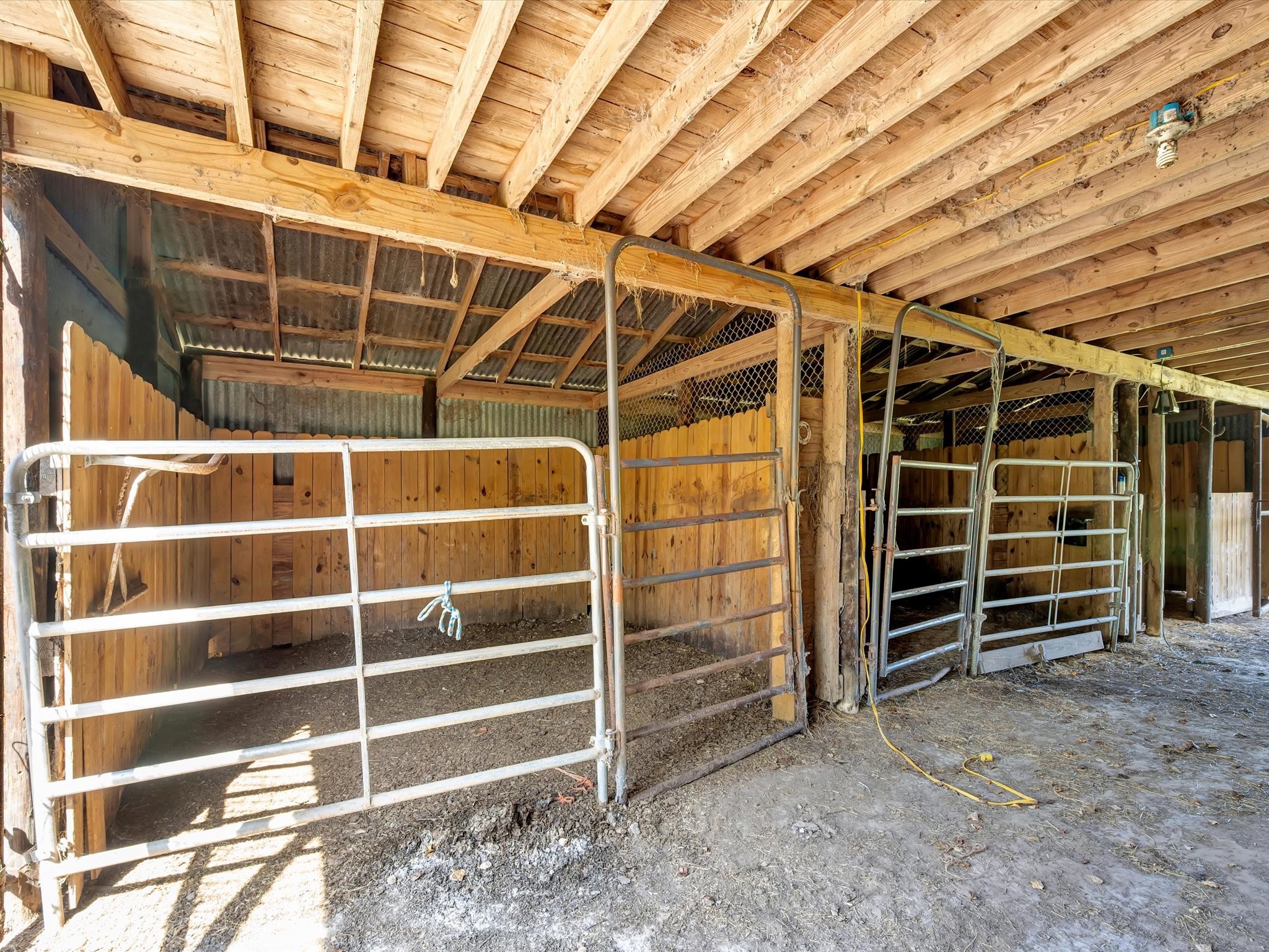 Spacious horse barn with stalls.