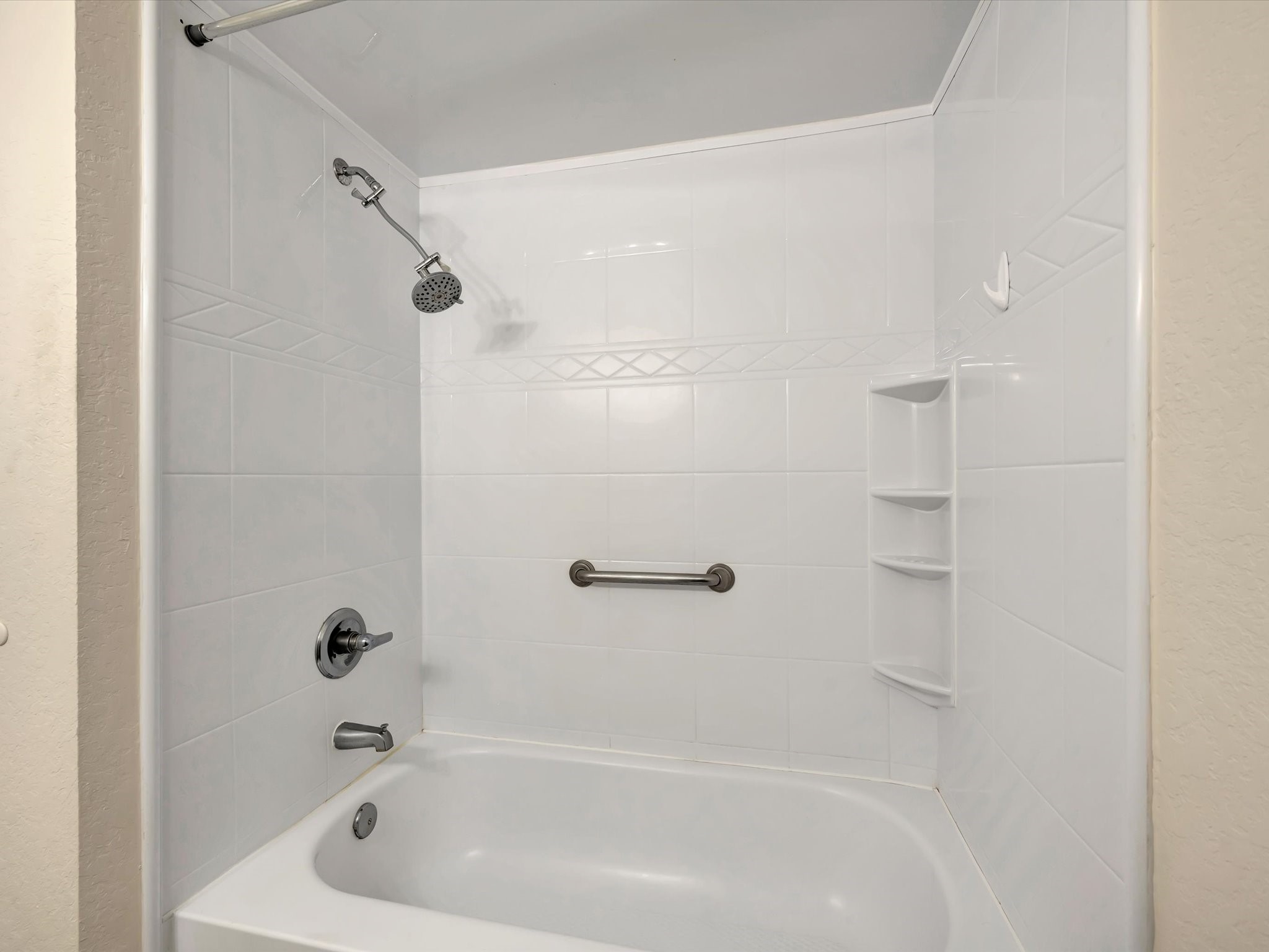 Beautifully updated tub and shower combination in the guest bathroom.