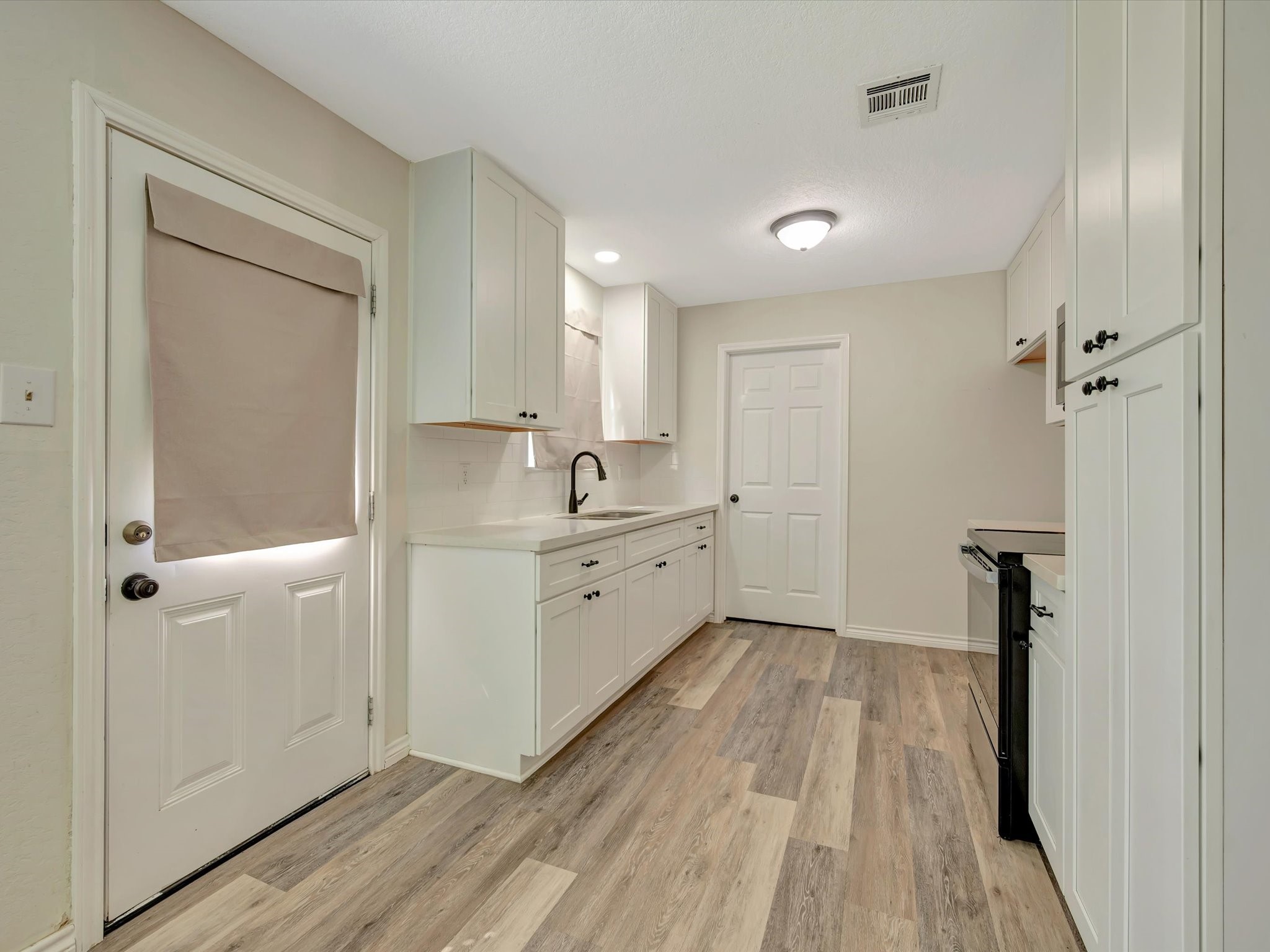 Open concept kitchen flowing seamlessly into the dining area. a