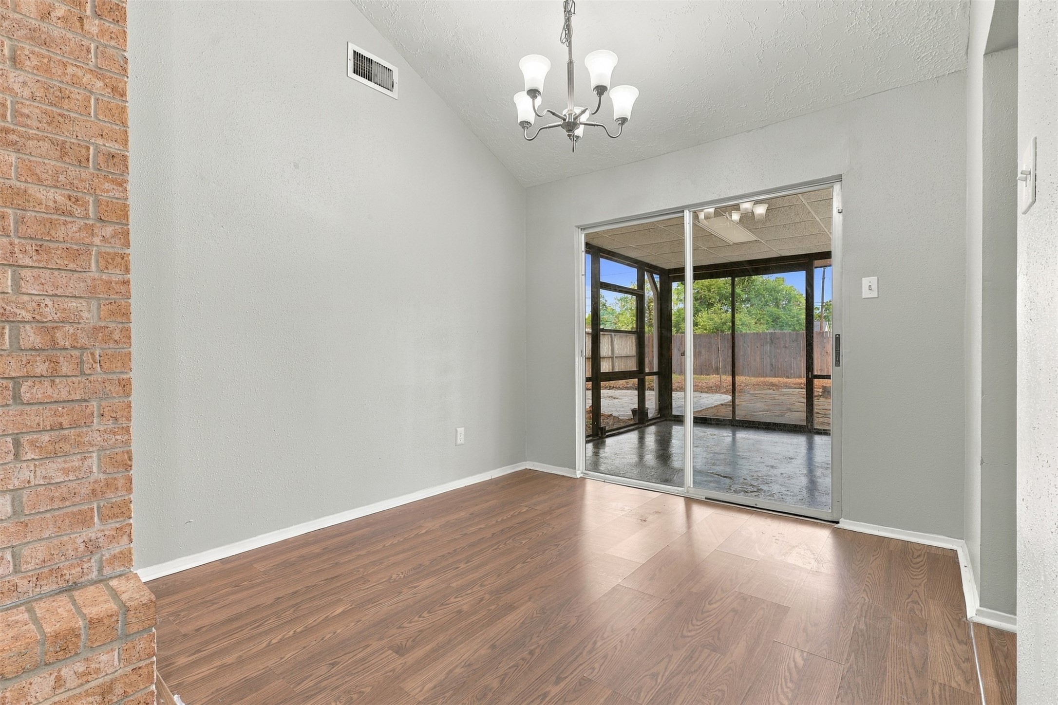 Dining area sits beside the kitchen and opens to the sunroom, creating an easy flow for everyday meals and entertaining.