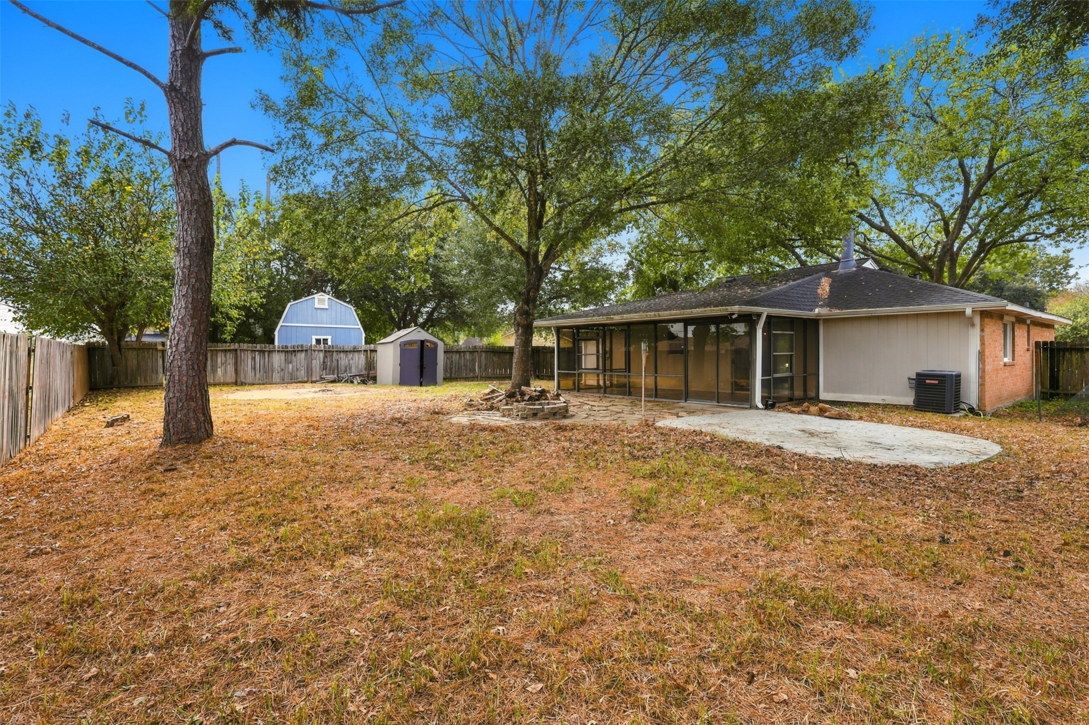 Spacious backyard features mature trees and room for outdoor seating, gardening, or recreation, with no back neighbors.