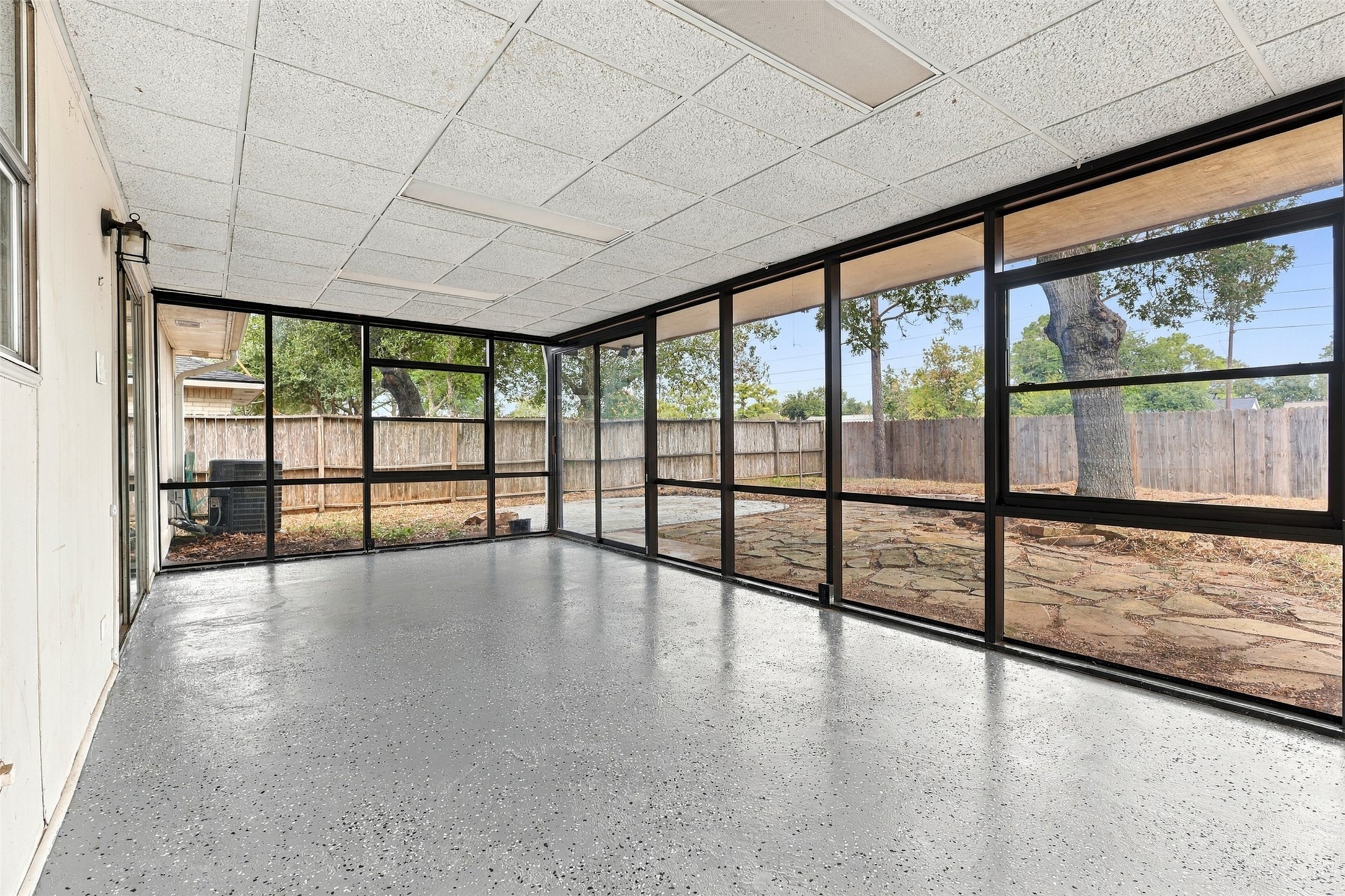The 230-square-foot sunroom features walls of windows and backyard viewsan inviting setting for a sitting area, hobbies, or a home office.