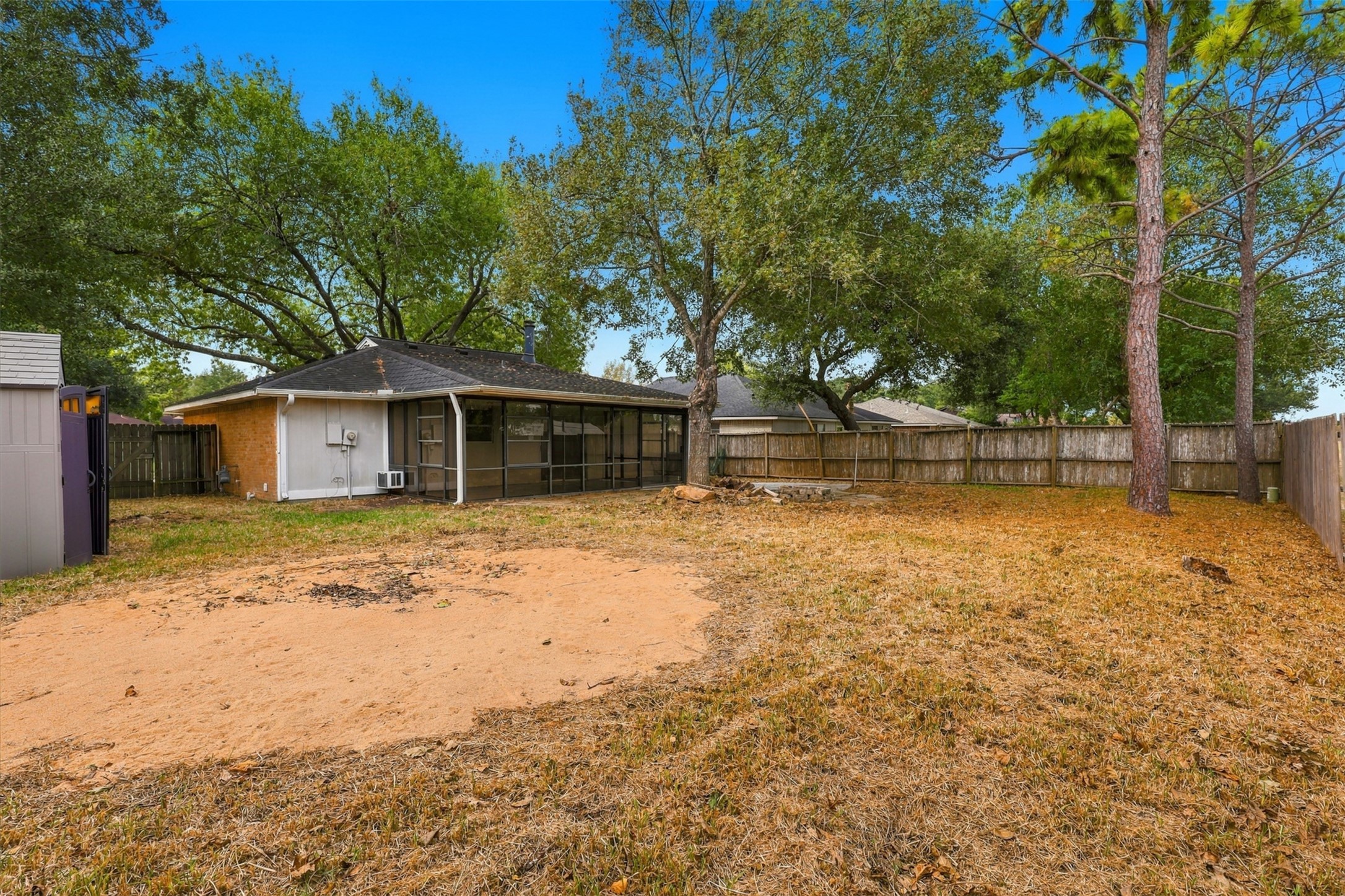 Another backyard perspective showcases the outdoor space and rear sunroom on this 7,645-square-foot lot.