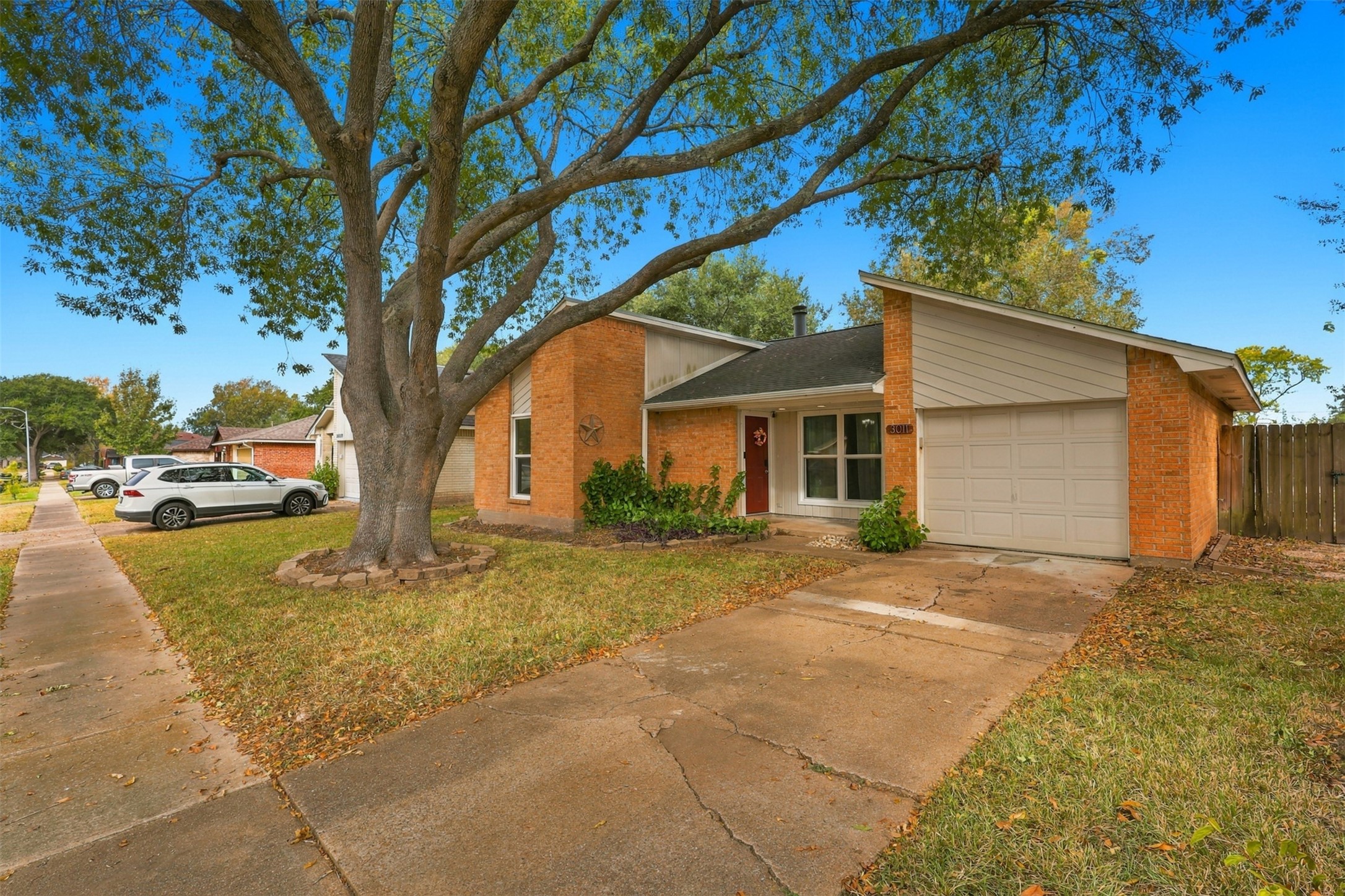 Driveway that leads to the attached garage, with a walkway connecting to the covered front entry.