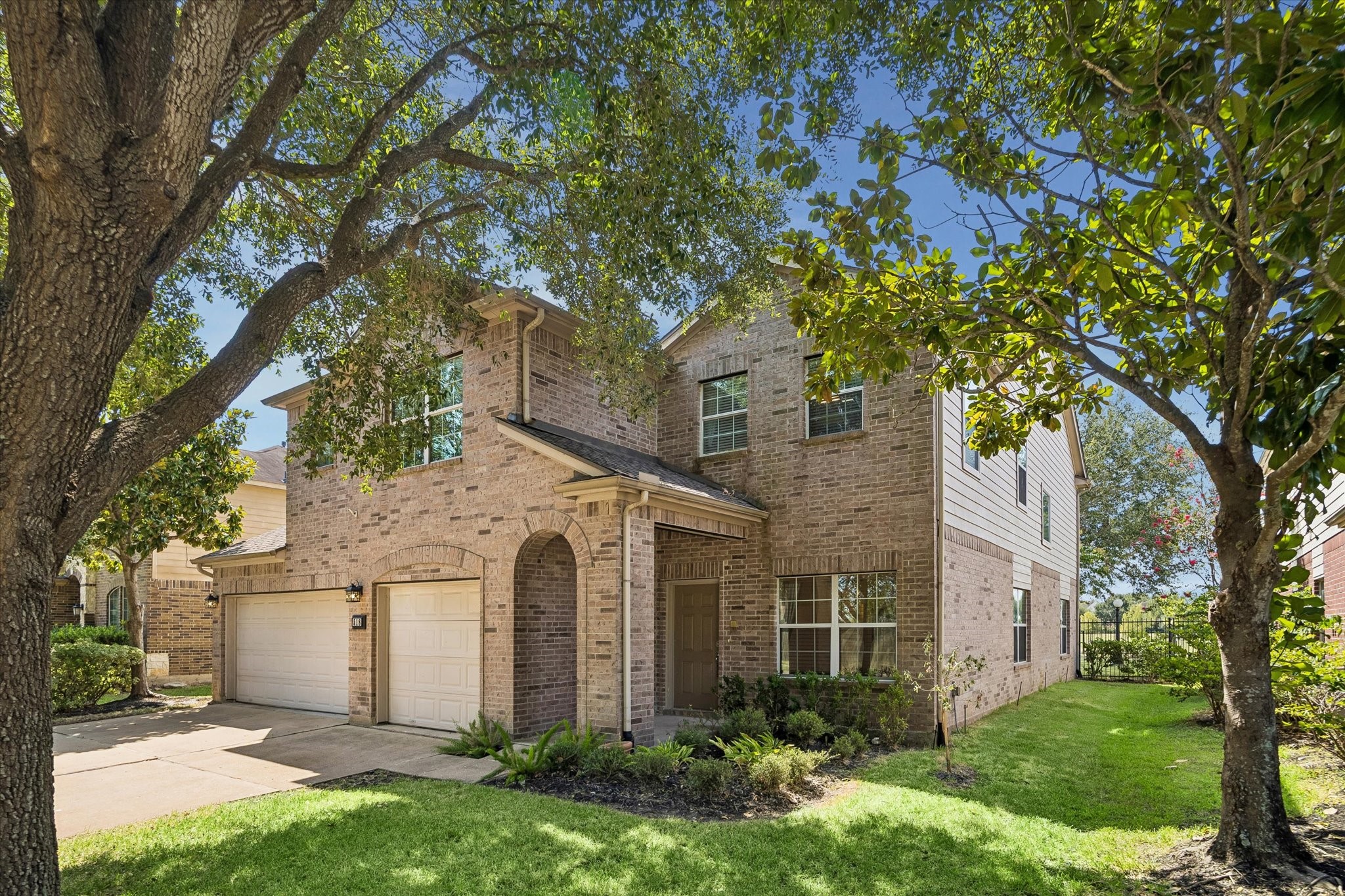Charming two-story brick home with a three-car garage, nestled among mature trees and lush landscaping, offers inviting curb appeal. Charming two-story brick home with a three-car garage, nestled among mature trees and lush landscaping, offers inviting curb appeal.
