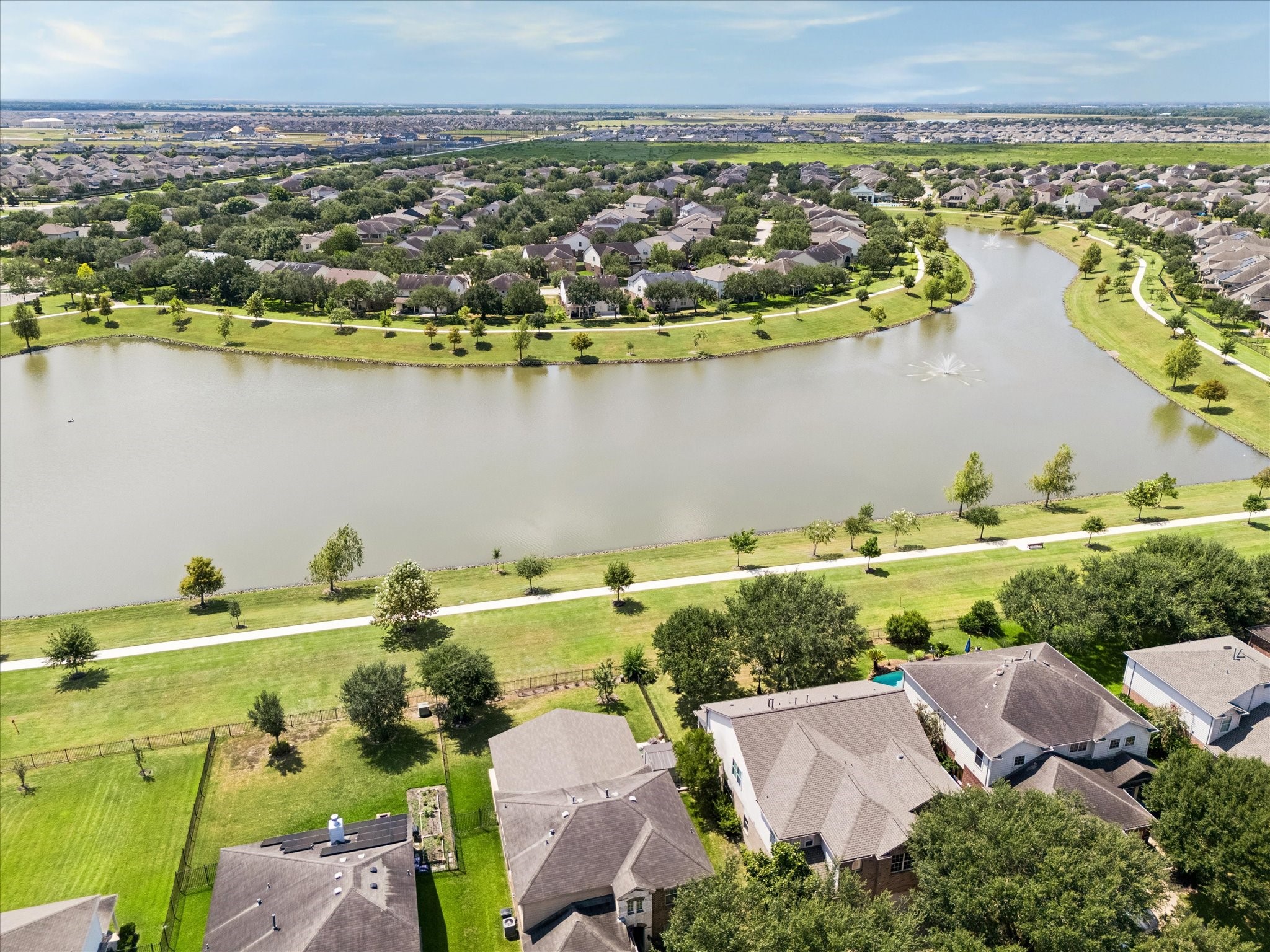 Discover serene lakeside living in a vibrant community, featuring picturesque walking paths and lush greenery, perfect for outdoor enthusiasts. Enjoy this view from your back patio. Discover serene lakeside living in a vibrant community, featuring picturesque walking paths and lush greenery, perfect for outdoor enthusiasts. Enjoy this view from your back patio.