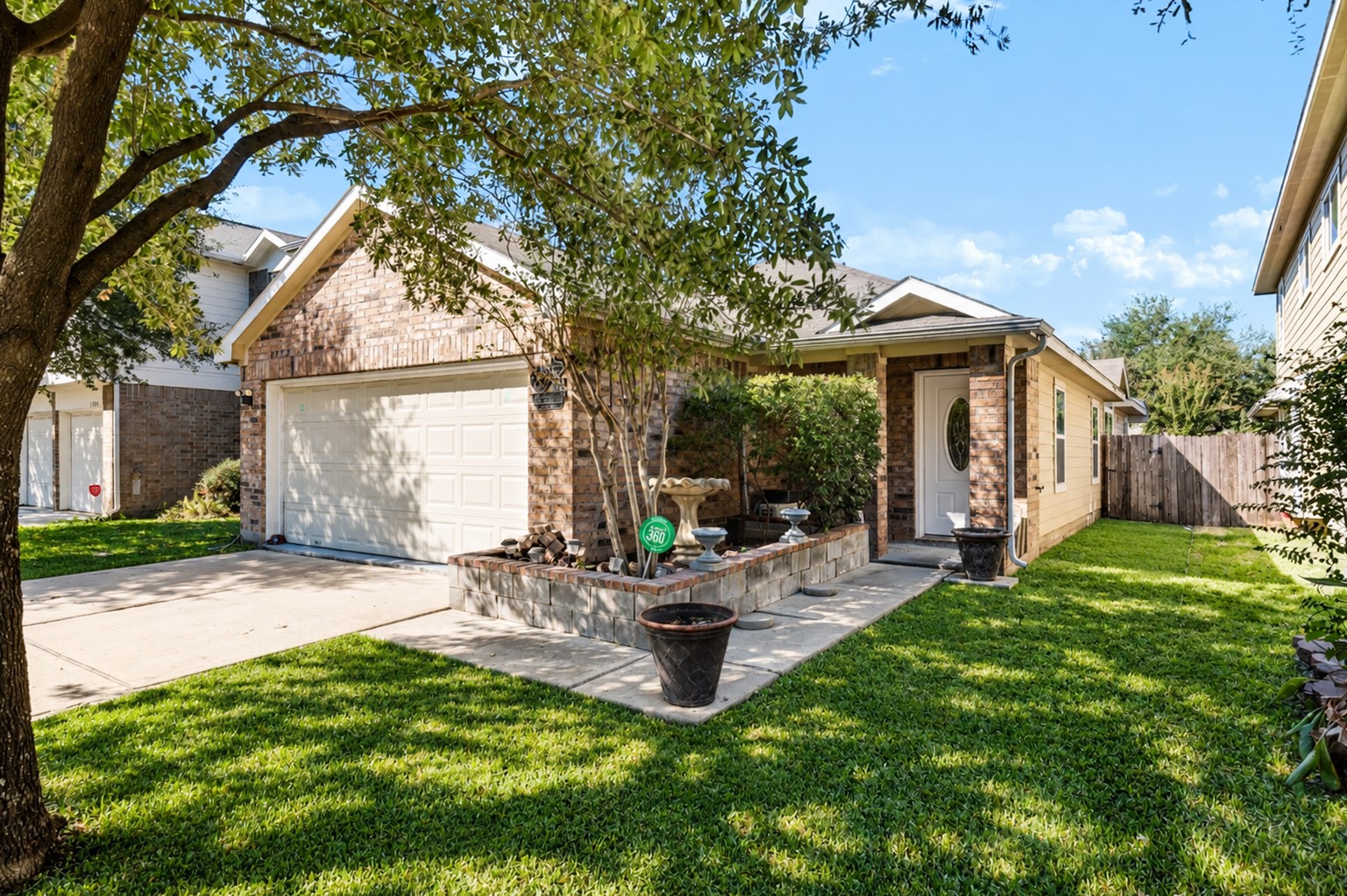 Pictured has been altered to portray future artificial turf ( not installed yet). Attractive single-family residence with a traditional brick facade. The property boasts excellent curb appeal with mature landscaping and a welcoming front porch, located on a quiet, tree-lined street