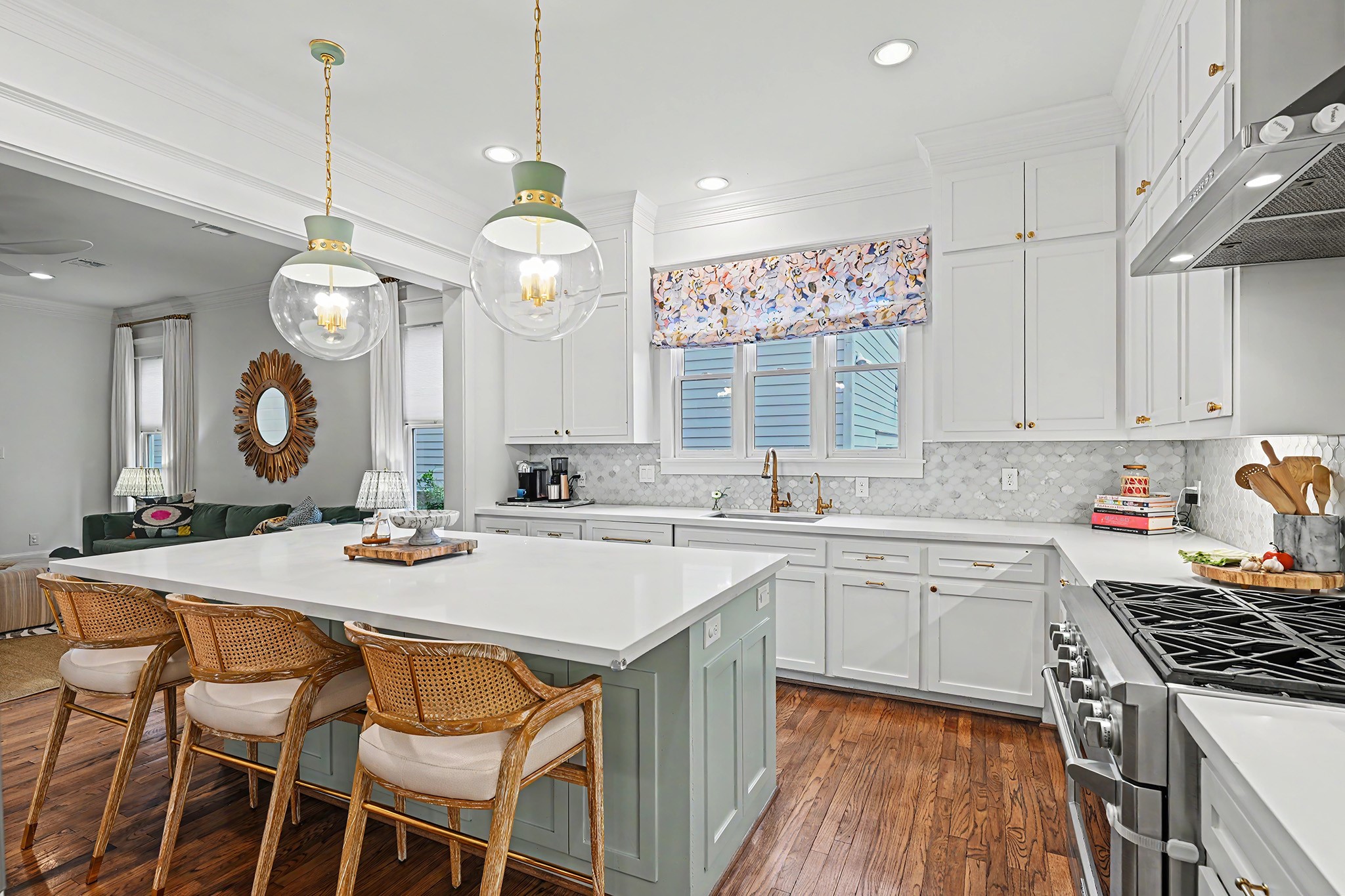 The kitchen highlights include beautiful pendant lights over the island, 6 burner gas range and gorgeous tile backsplash.