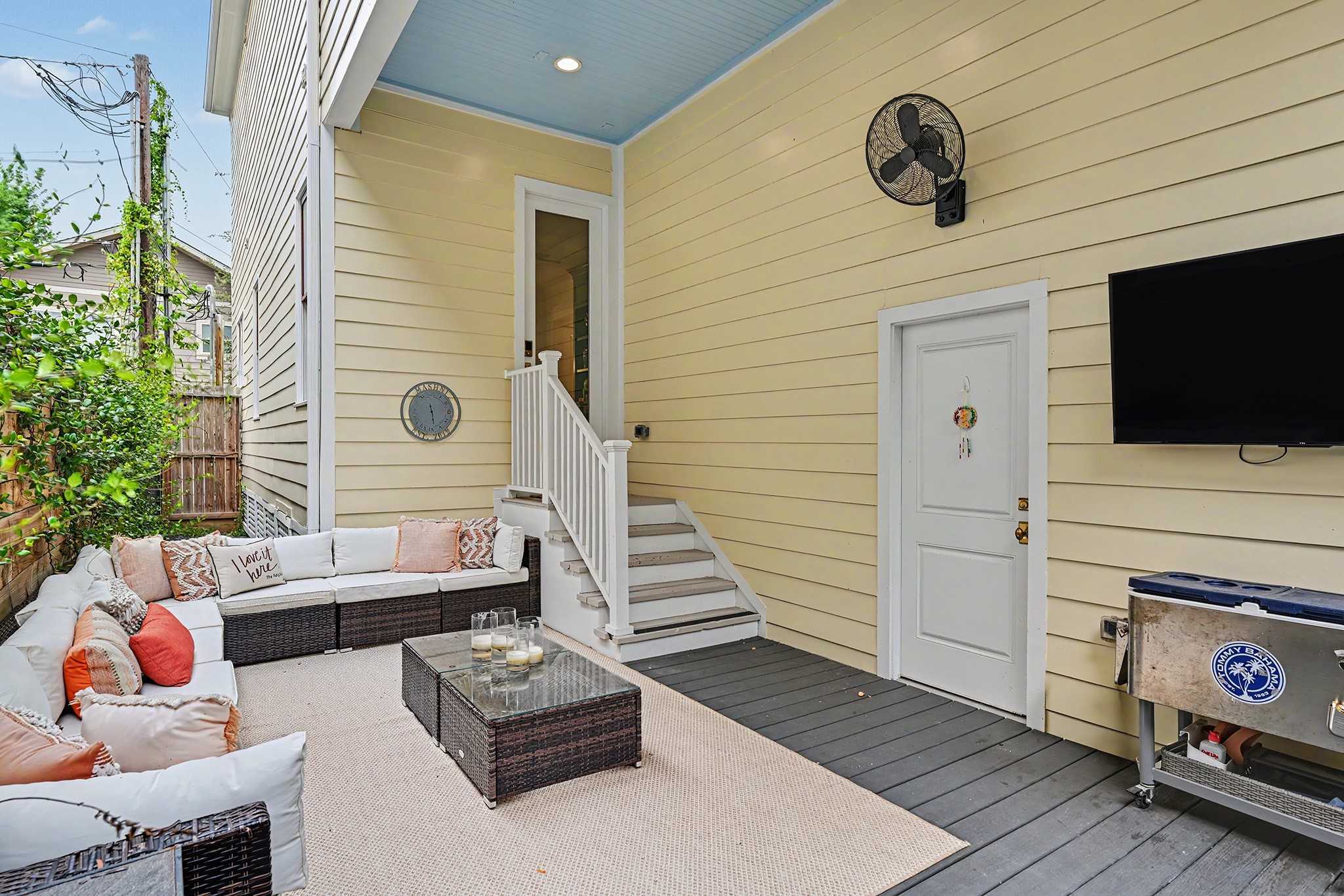 Your outdoor room! Staircase from the family room comes down to the patio area  with custom decking.