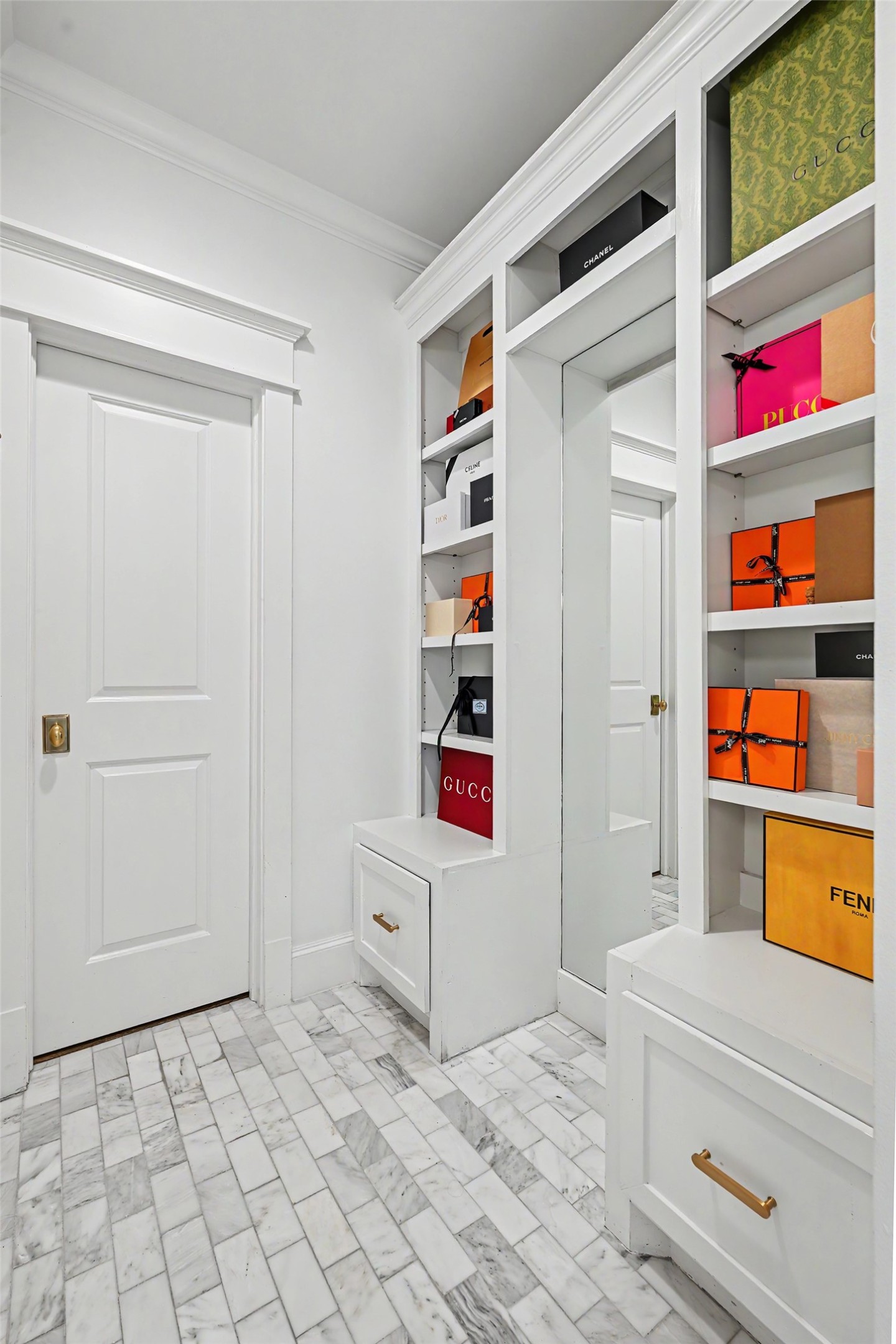 Auxiliary area of the primary bathroom with full length mirror and built-in shelving for your needs. Private water closet too.