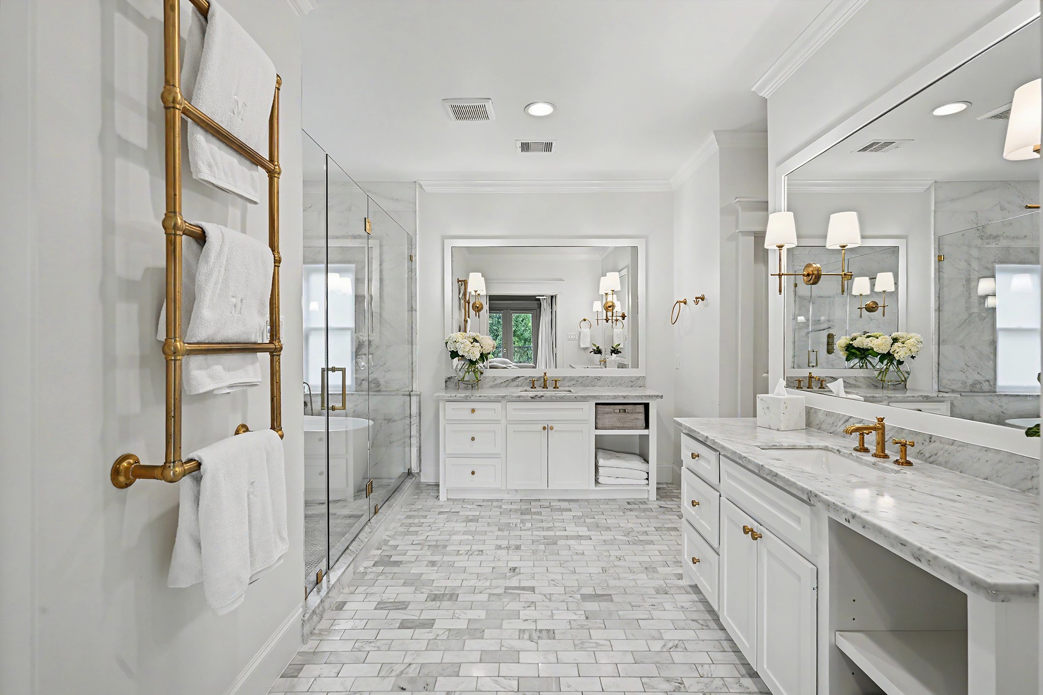 Double doors open into the spa-like primary bathroom which boasts marble counters, double sinks, wet room, marble floors and towel warmer.