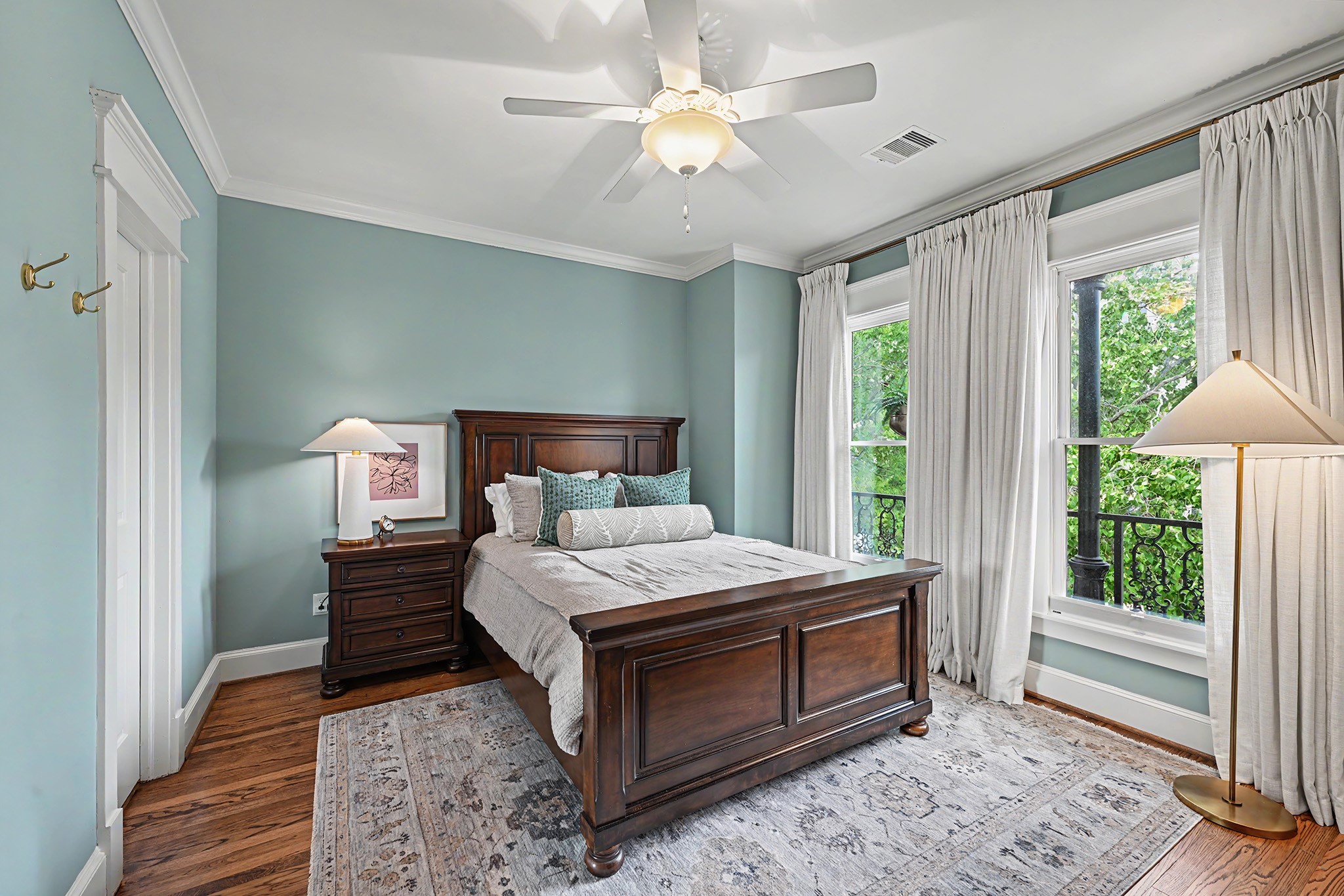 One of two upstairs secondary bedrooms with hardwood floors, window treatments and good closet space.