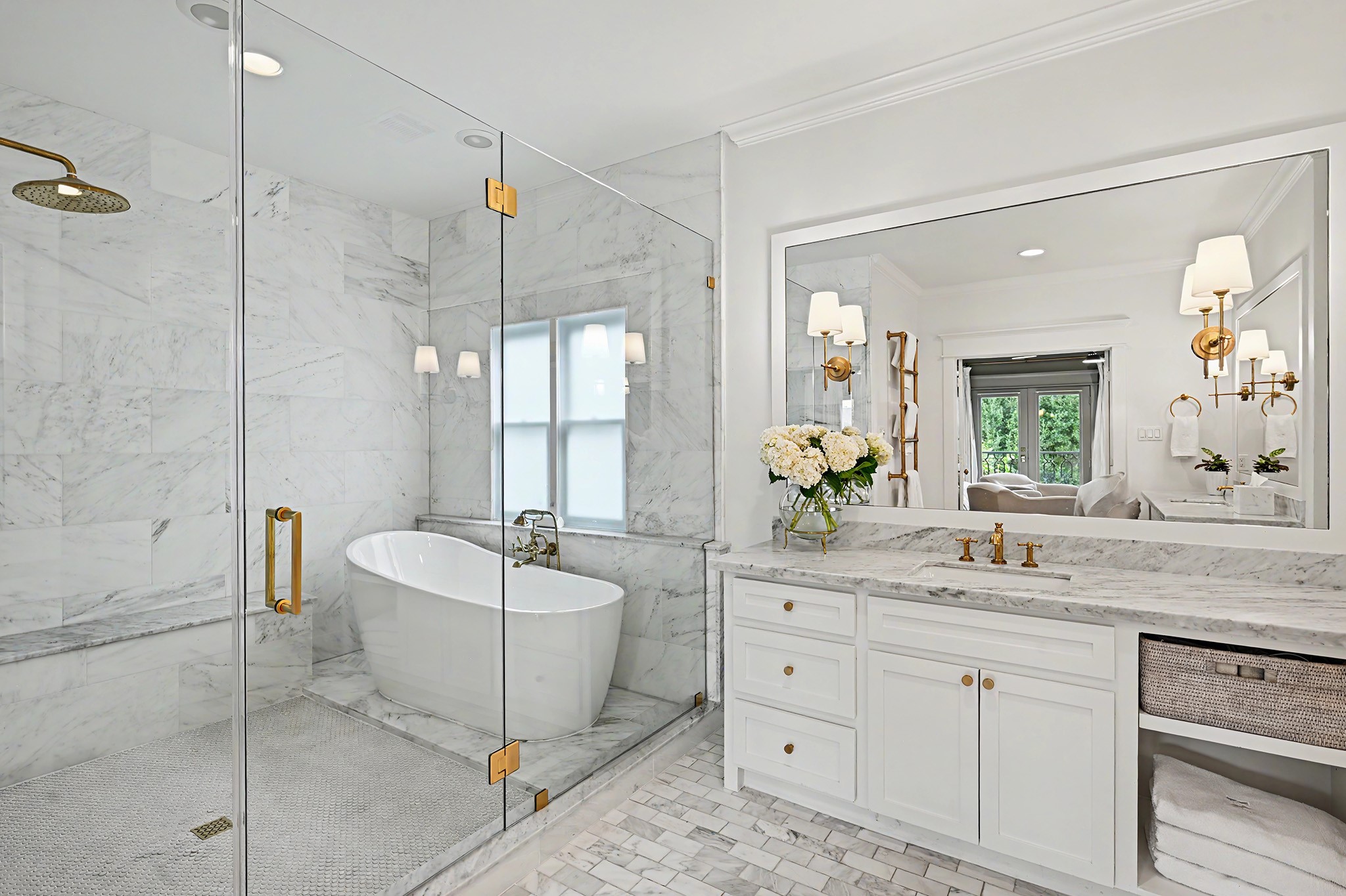 Frameless glass enclosed wet room with shower and tub combination.
