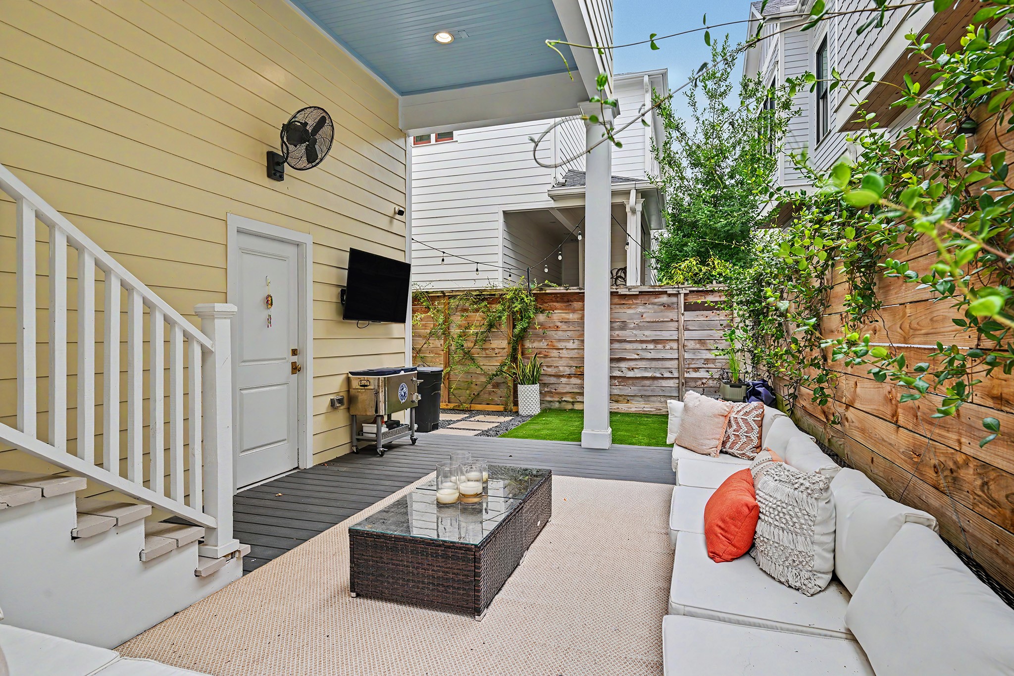 Turf area beyond the deck gives you the right amount of backyard greenspace. Door goes to the two-car attached garage with epoxy flooring and 14 foot ceiling for future storage space.