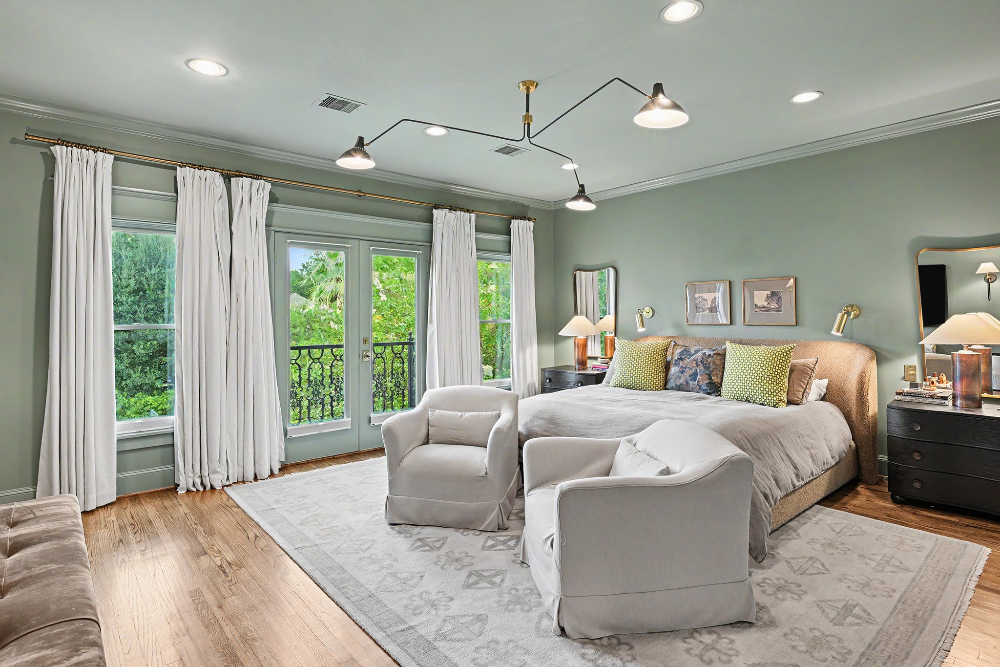 Pure divine! Primary bedroom suite is well-appointed with sitting area, wall reading lights, blackout window treatments, private balcony and two walk-in closets.
