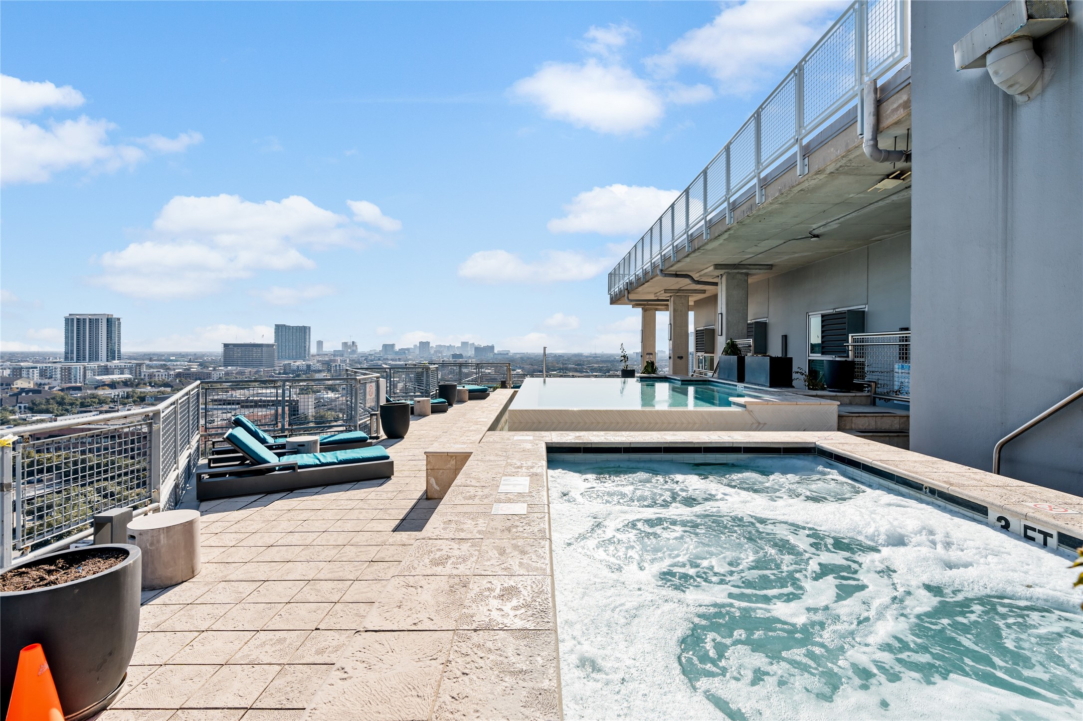 The rooftop terrace extends the resort style experience with a spa, lounge areas and expansive skyline views, offering a private escape above the city.