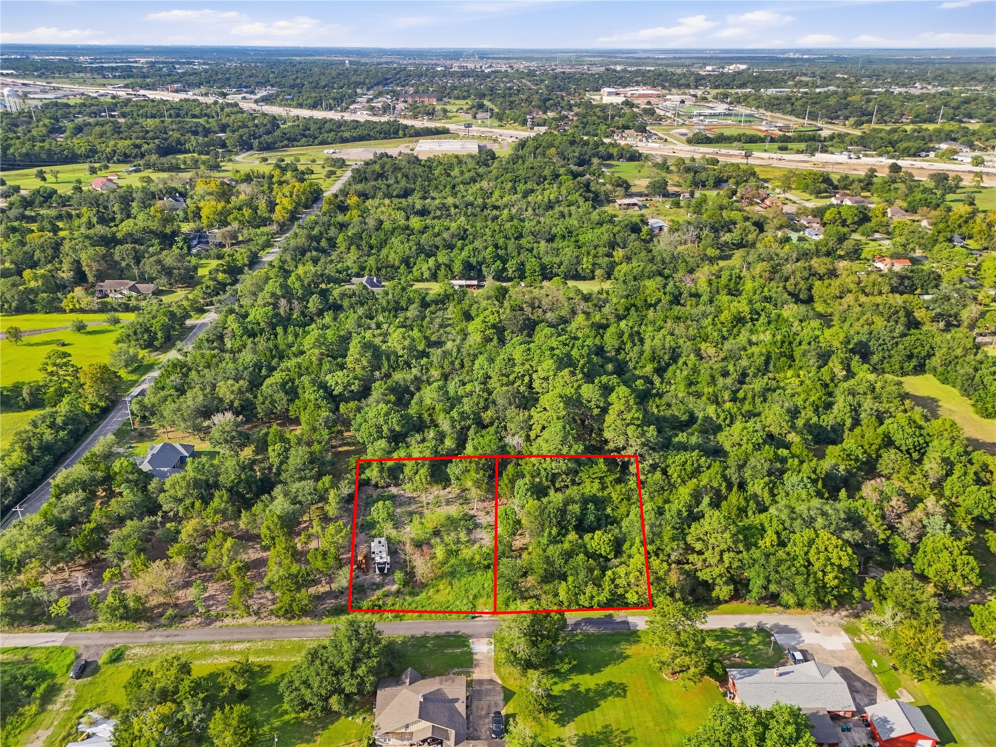 Aerial view highlighting both parcels and their road frontage.