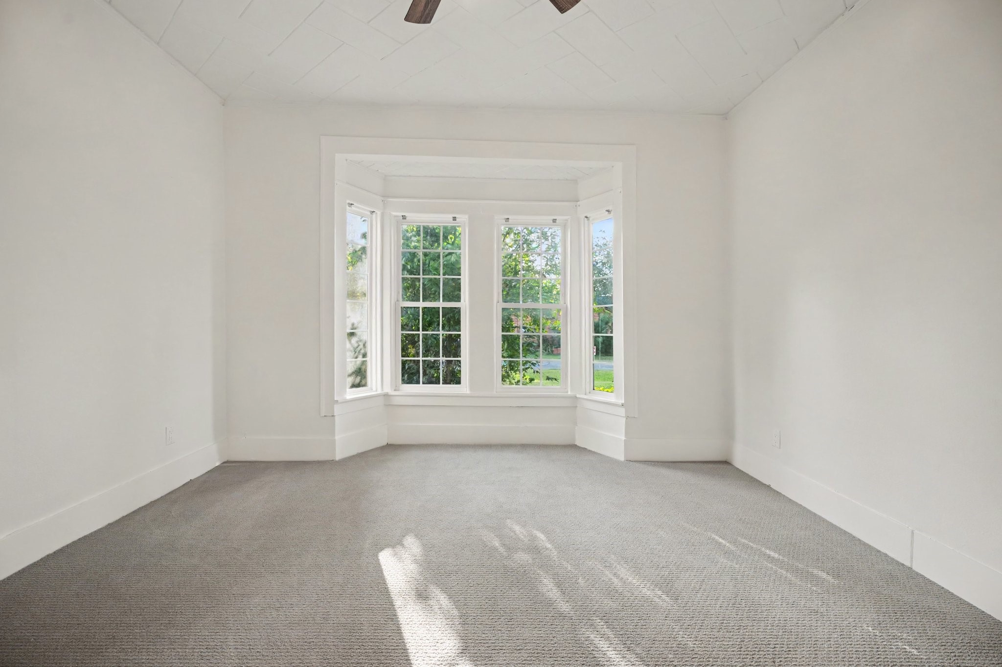 Another large bedroom with more natural lighting