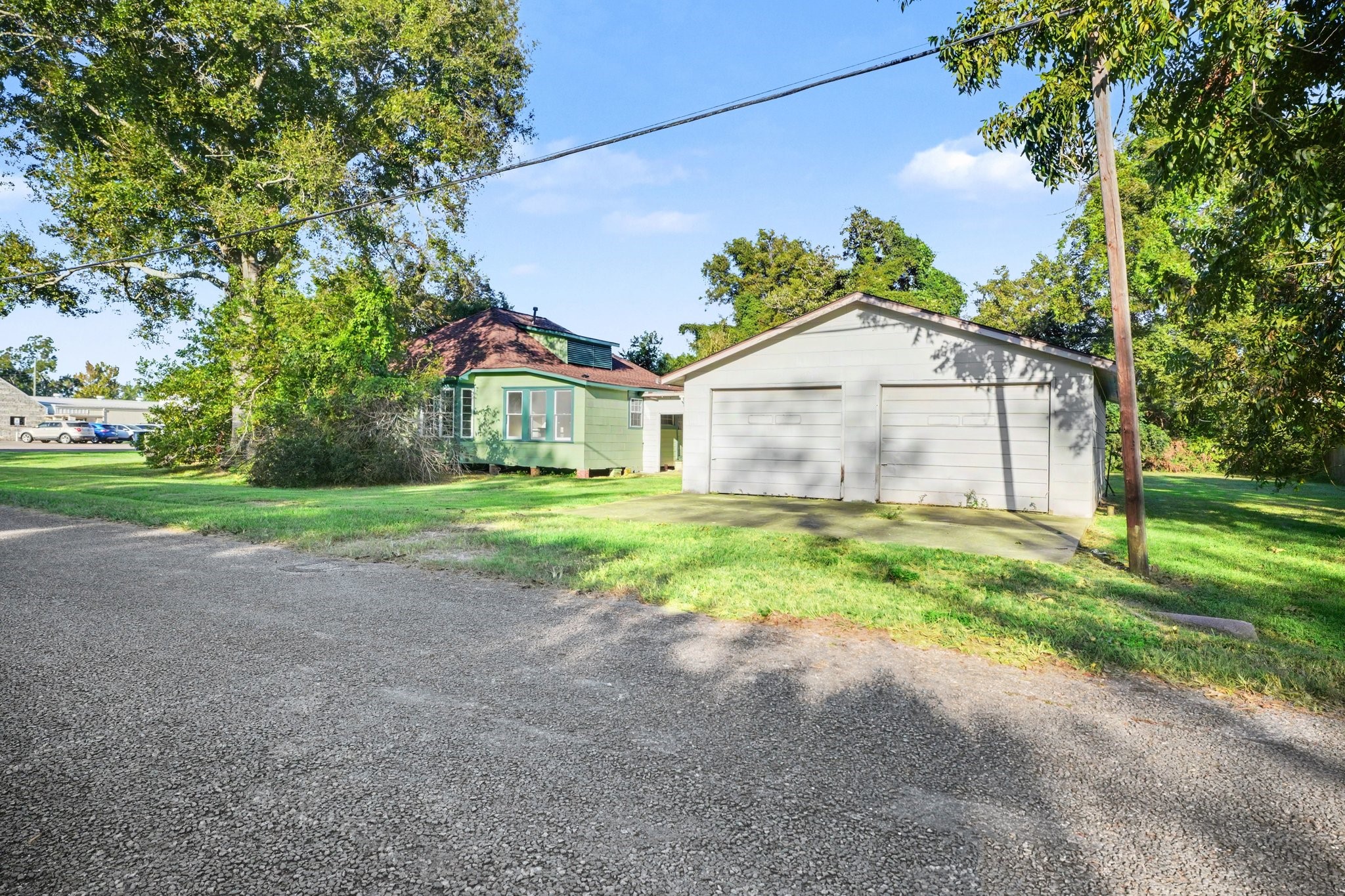 Detached 2 car oversized garage with covered enclosed back patio to connect house with garage for unloading made easy