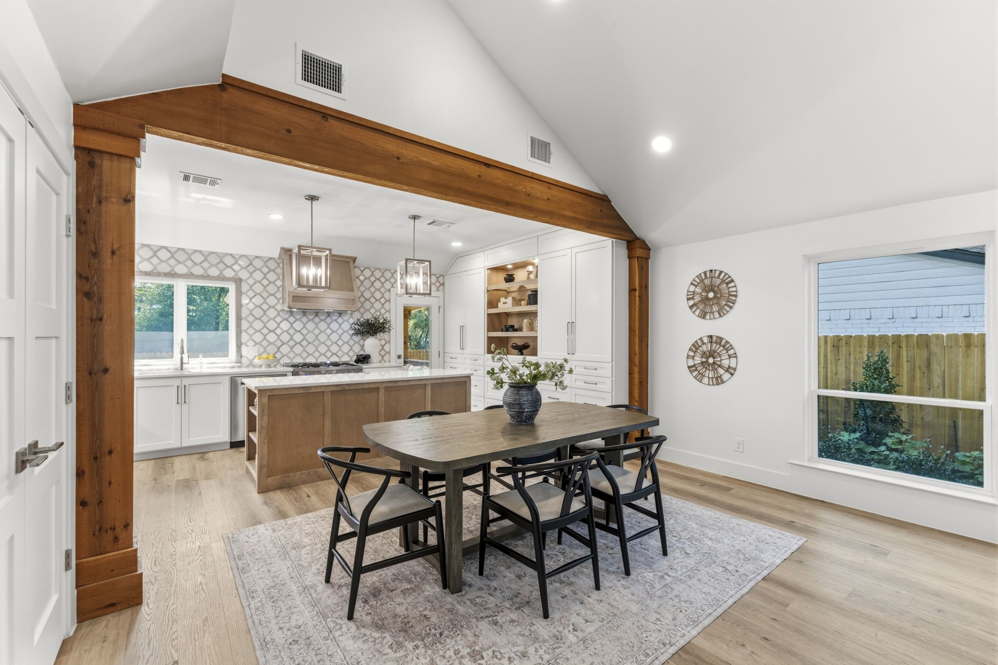 The dining area is perfectly positioned between the kitchen and living room, creating an ideal setting for everything from casual family meals to entertaining guests.