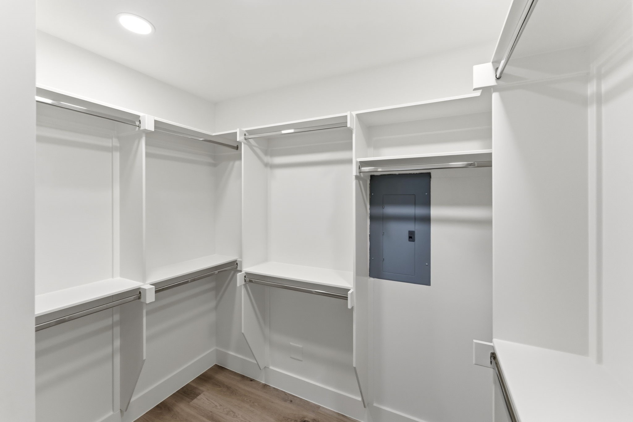 Primary closet boasts built-in shelving, double hanging rods, and dedicated storage areas, this spacious closet provides plenty of room for clothing, shoes, and accessories while keeping everything neatly organized and within easy reach.