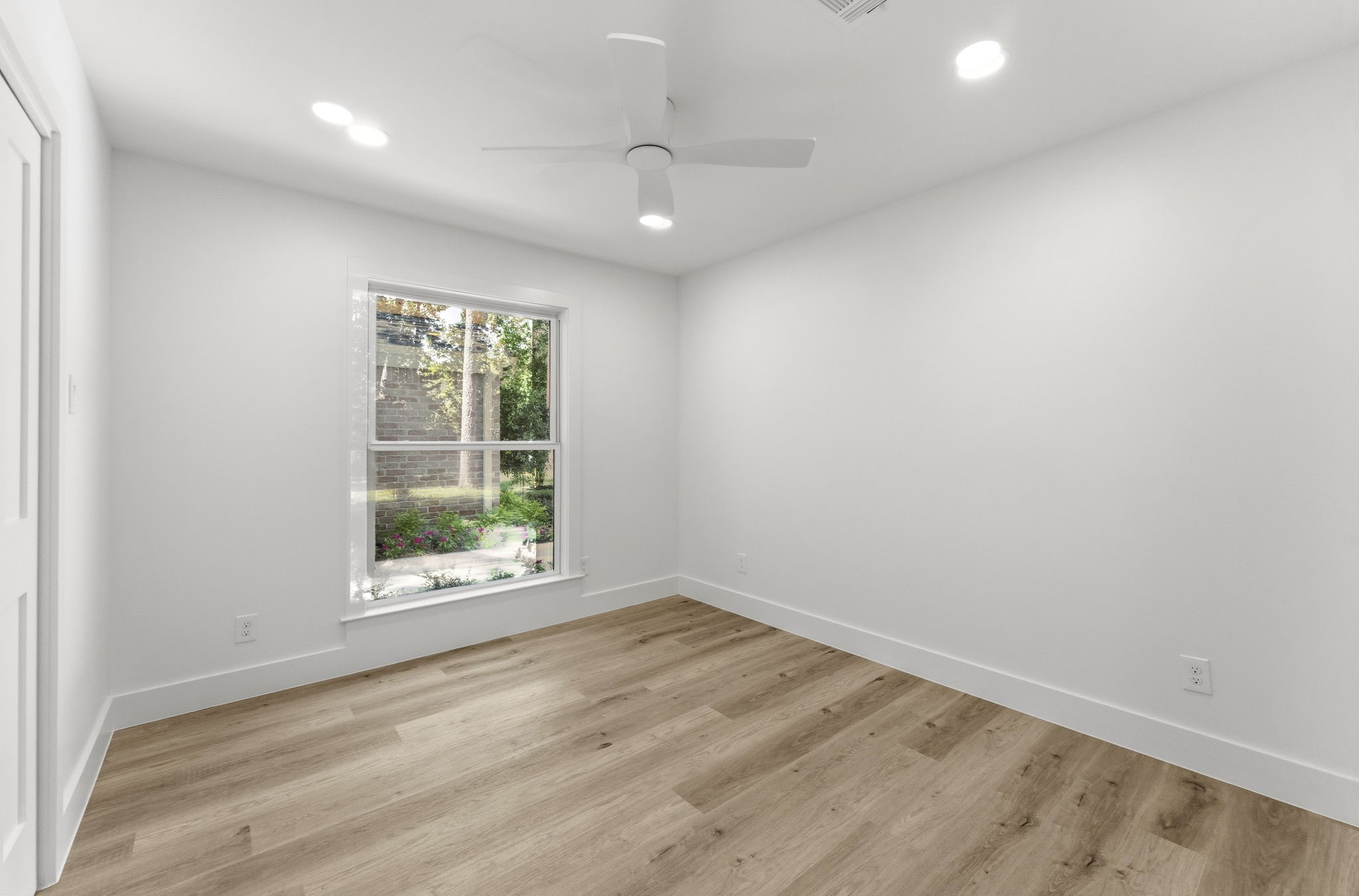 One of two spacious secondary bedrooms. This light-filled room offers the perfect space for family or guests.