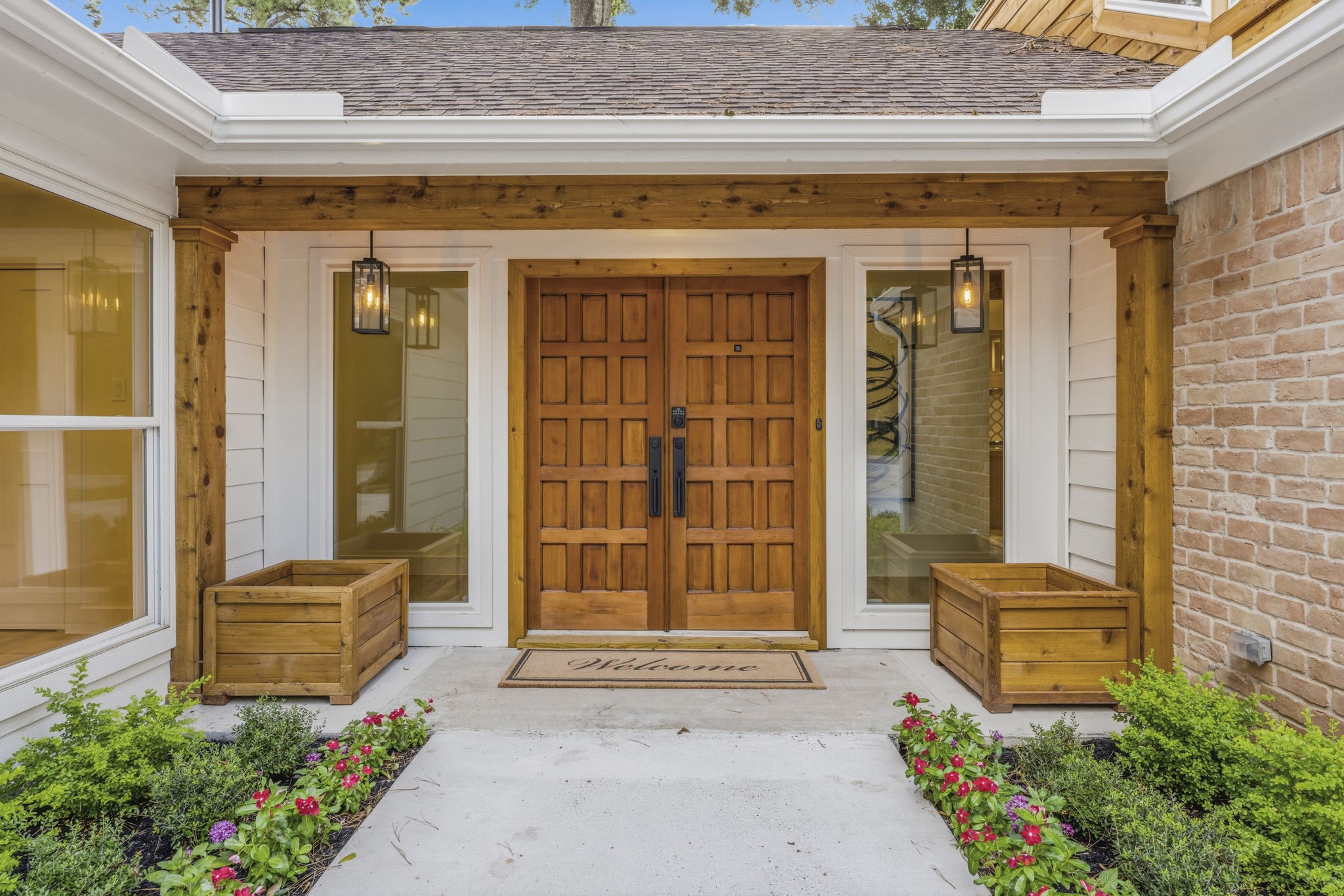 The original custom double front doors have been beautifully restored and enhanced, preserving the home's character while complementing its modern renovation.