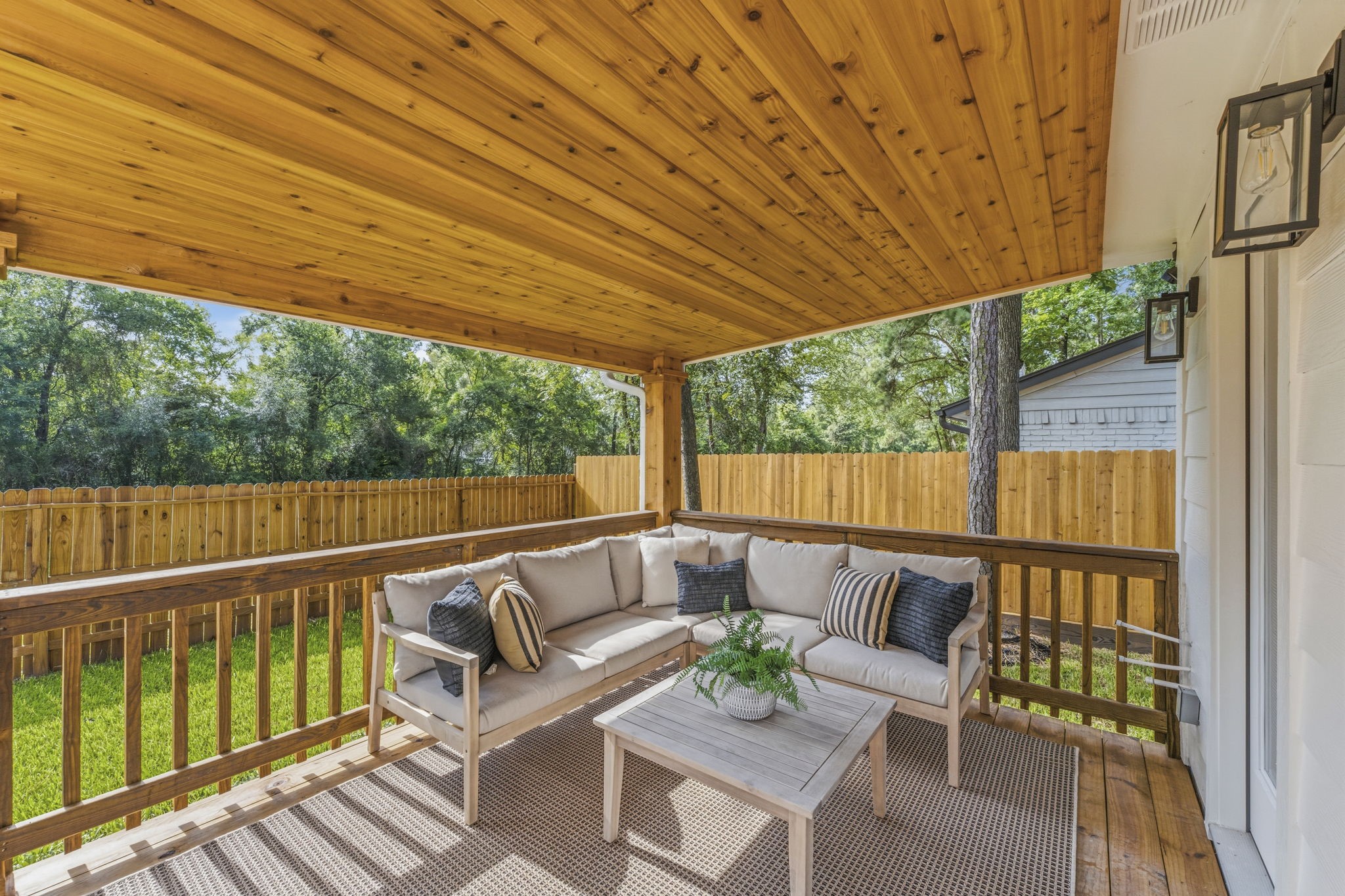 The brand-new covered patio creates an inviting extension of the home's living space.