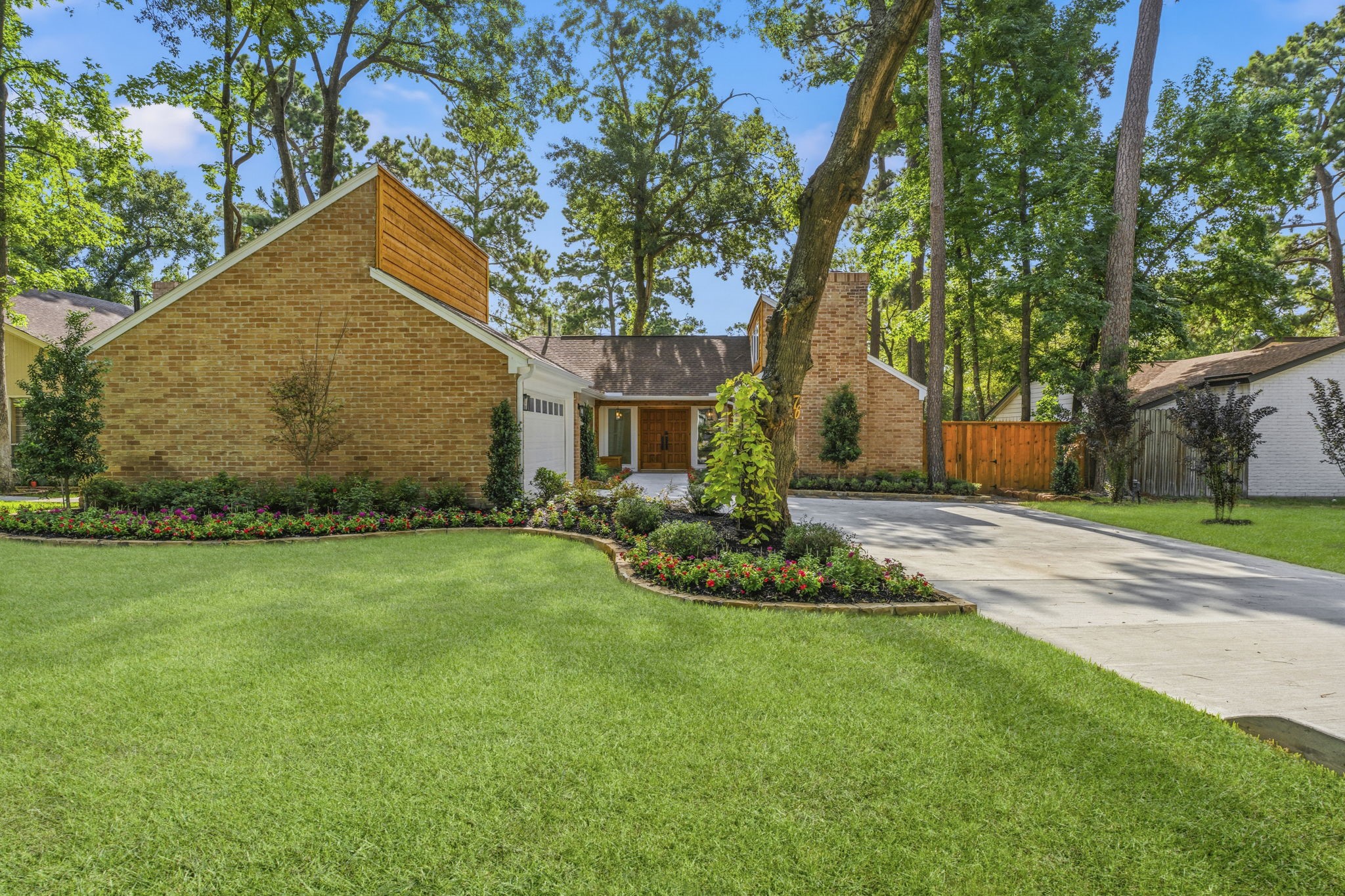 Professional landscaping, a newly expanded driveway, and timeless brick architecture with modern Hardie siding and cedar accents create exceptional curb appeal.