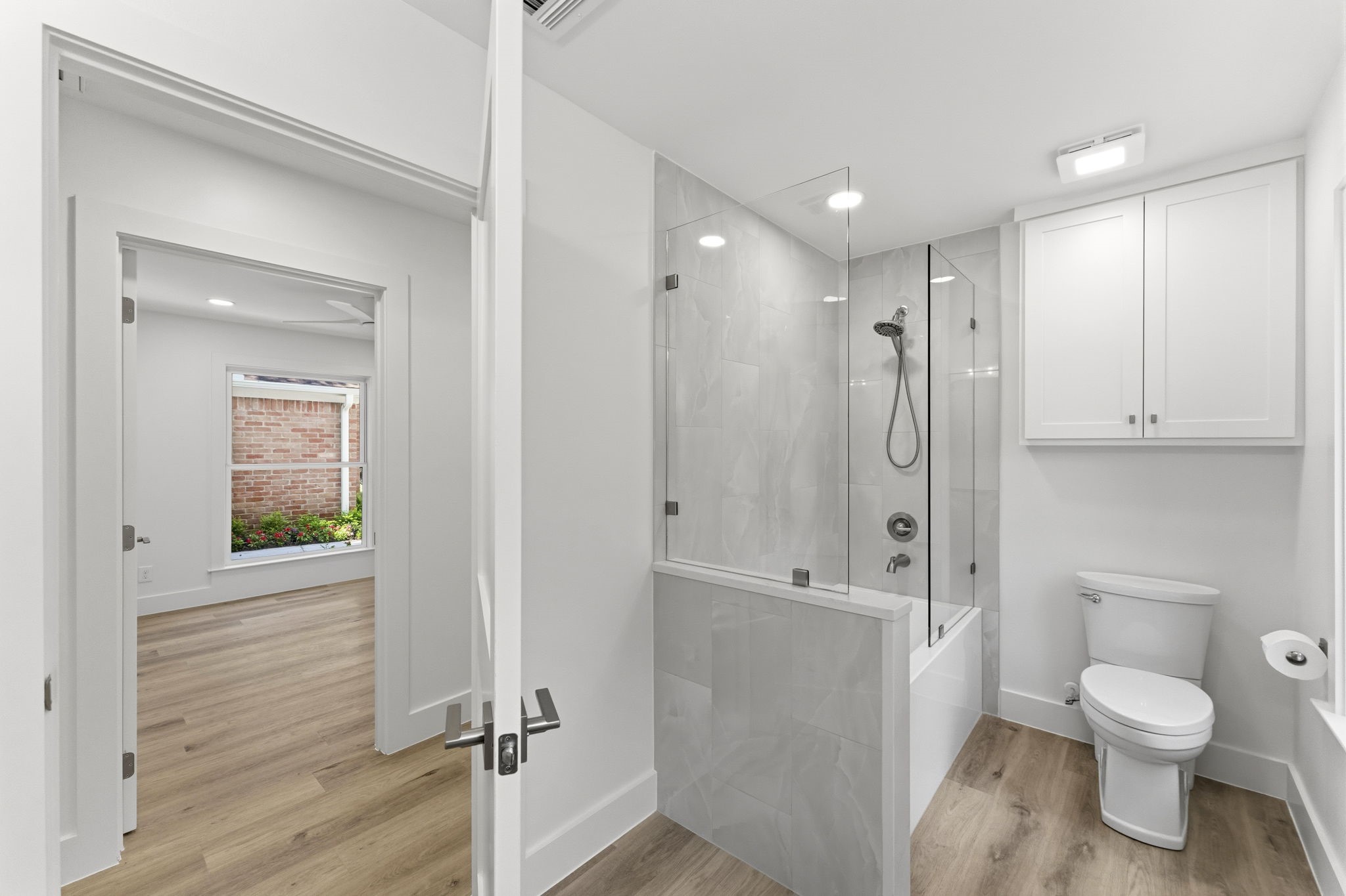Upgraded bathroom features a tiled tub and shower combination and is conveniently located adjacent to the secondary bedrooms.