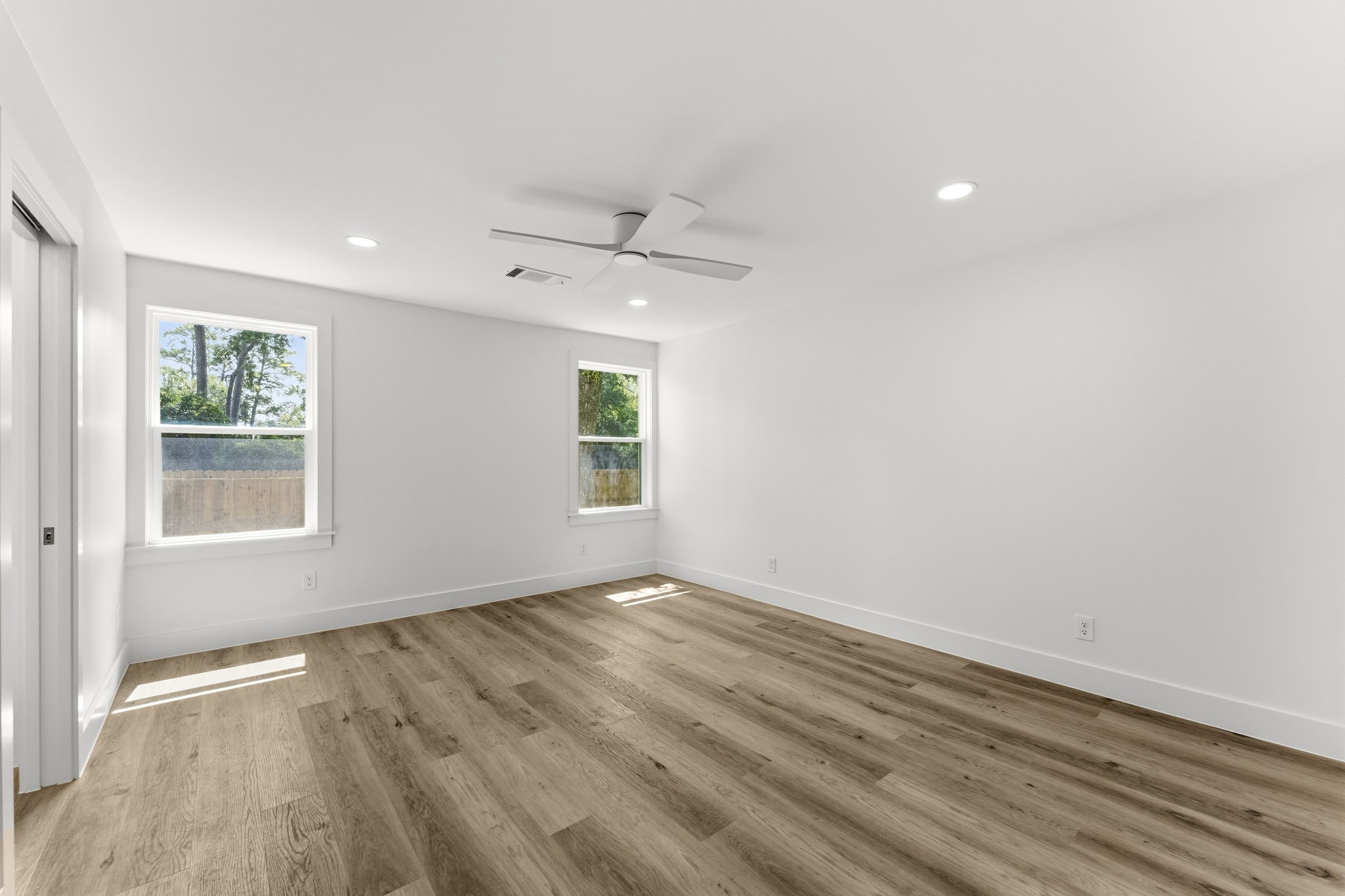 Designed as a true owner's retreat, the spacious primary suite easily accommodates a king-sized bed, additional seating, and features direct access to the luxurious en-suite bath and custom walk-in closet.