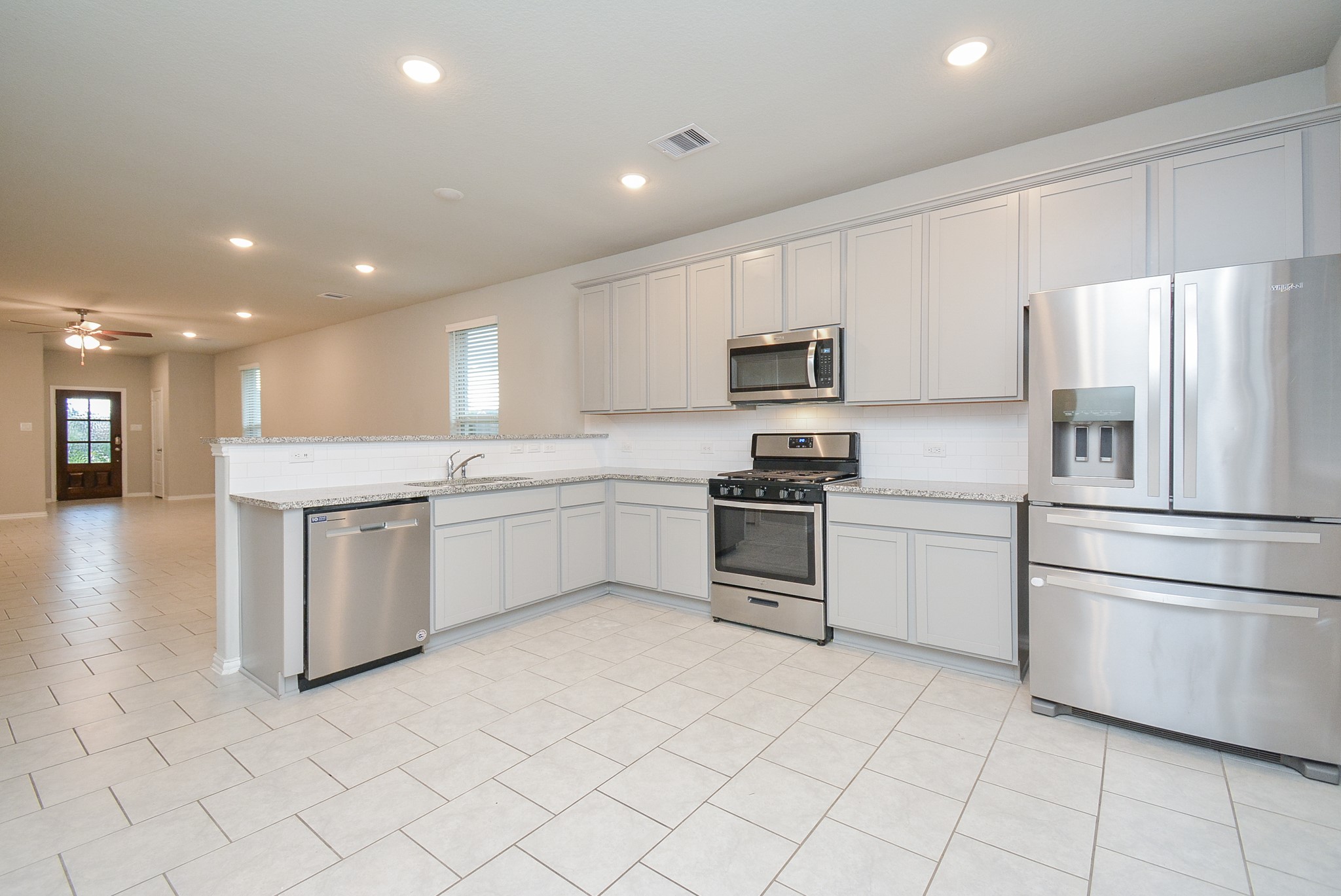 Tremendous floor space lets both cooks and eager helpers happily coexist. There's room for breakfast nook pieces, too, if you use any of the living space for formal dining.