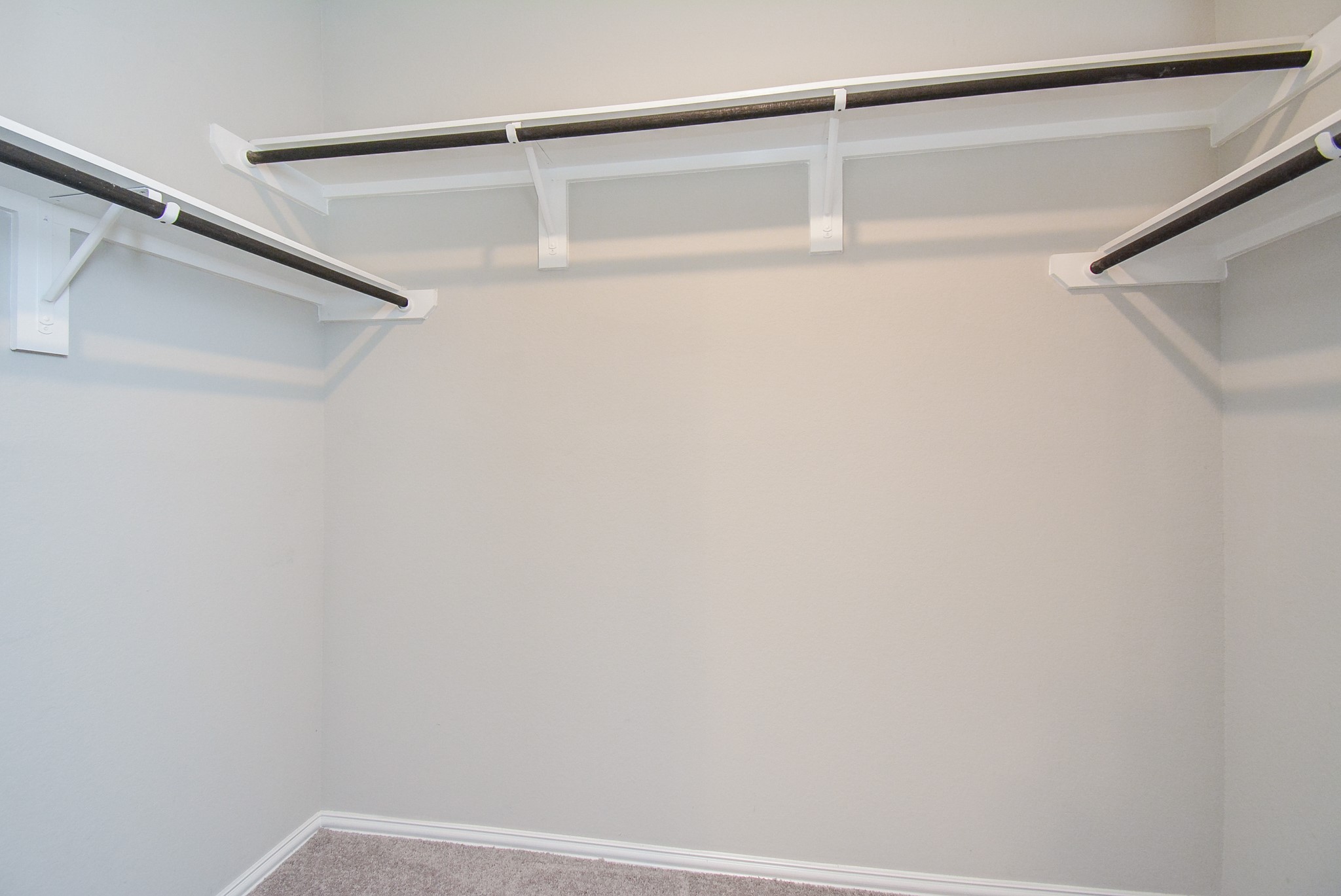 One can never have too many closets --- especially if they look like this carpeted primary walk-in!