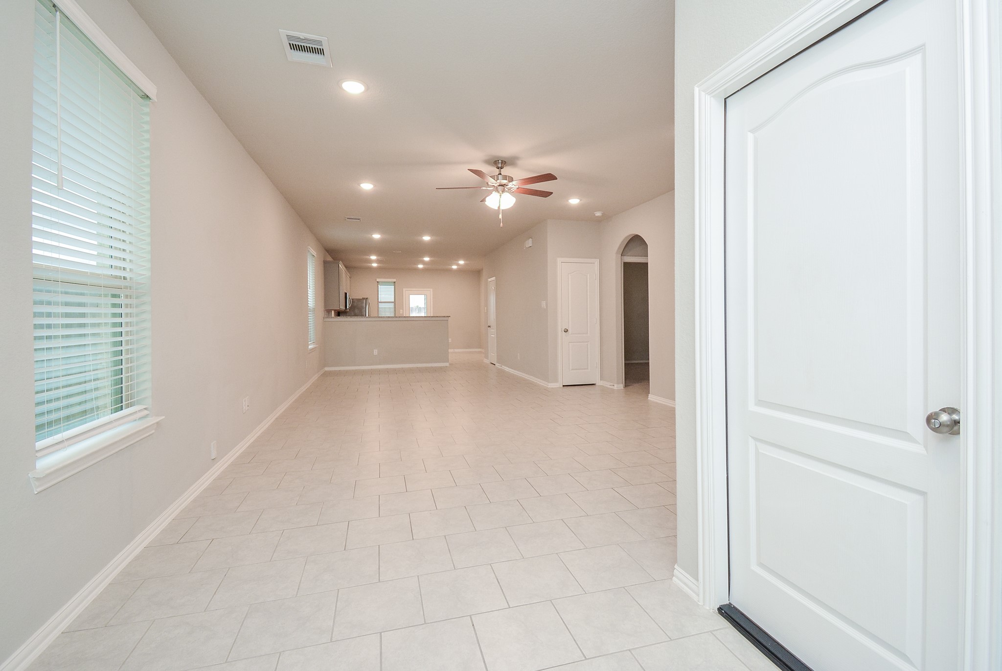 The beauty and versatility of the open floor plan is appreciated in this view from the front door, straight back to the patio door!